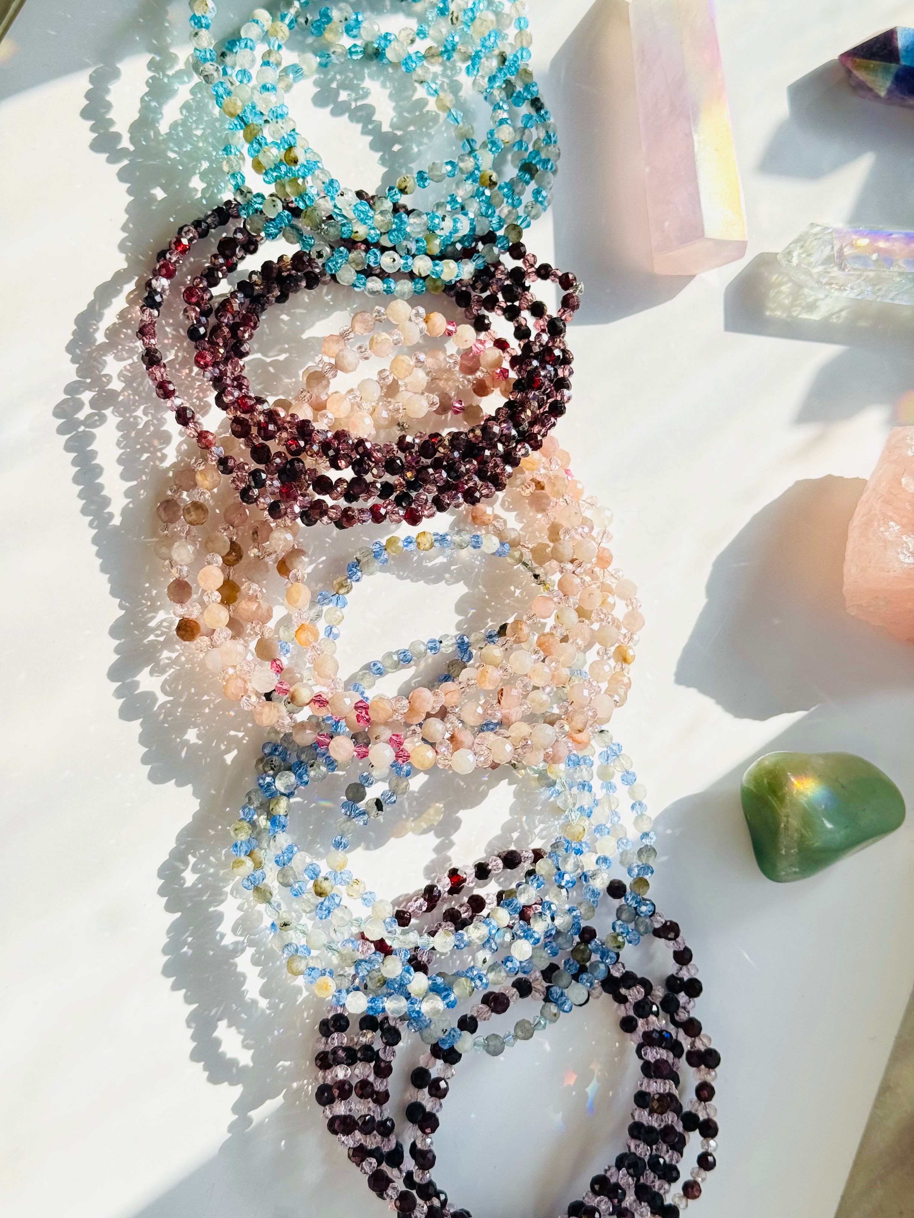 Assorted Colorful tantric necklaces on white surface