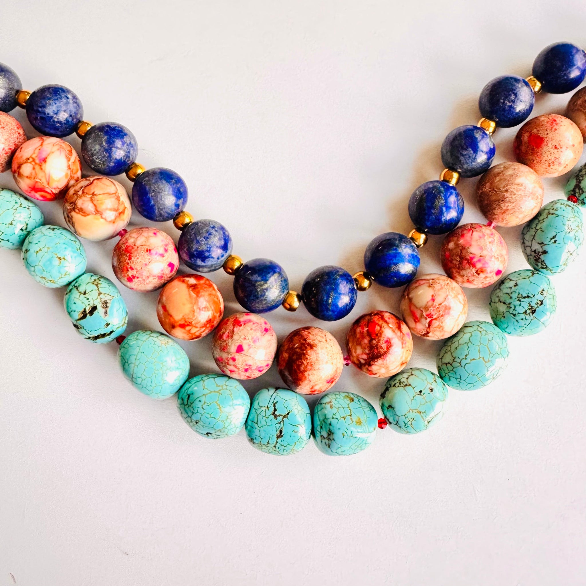 Necklaces with multicolored beads on a white background