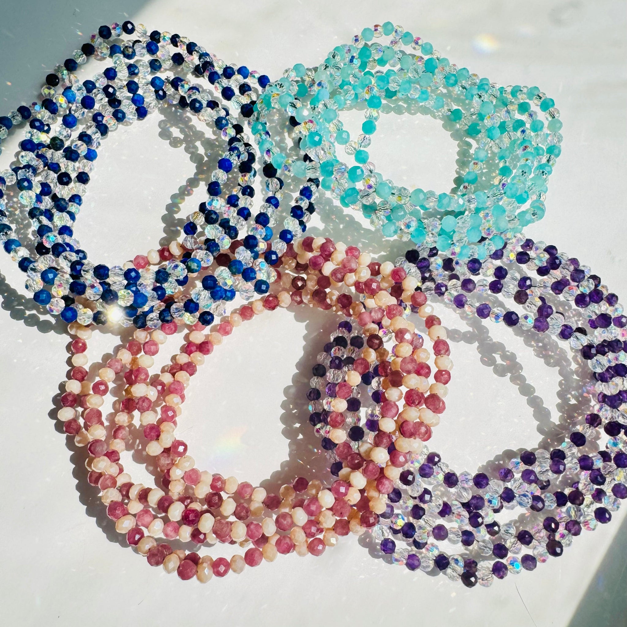colorful tantric necklace on white surface