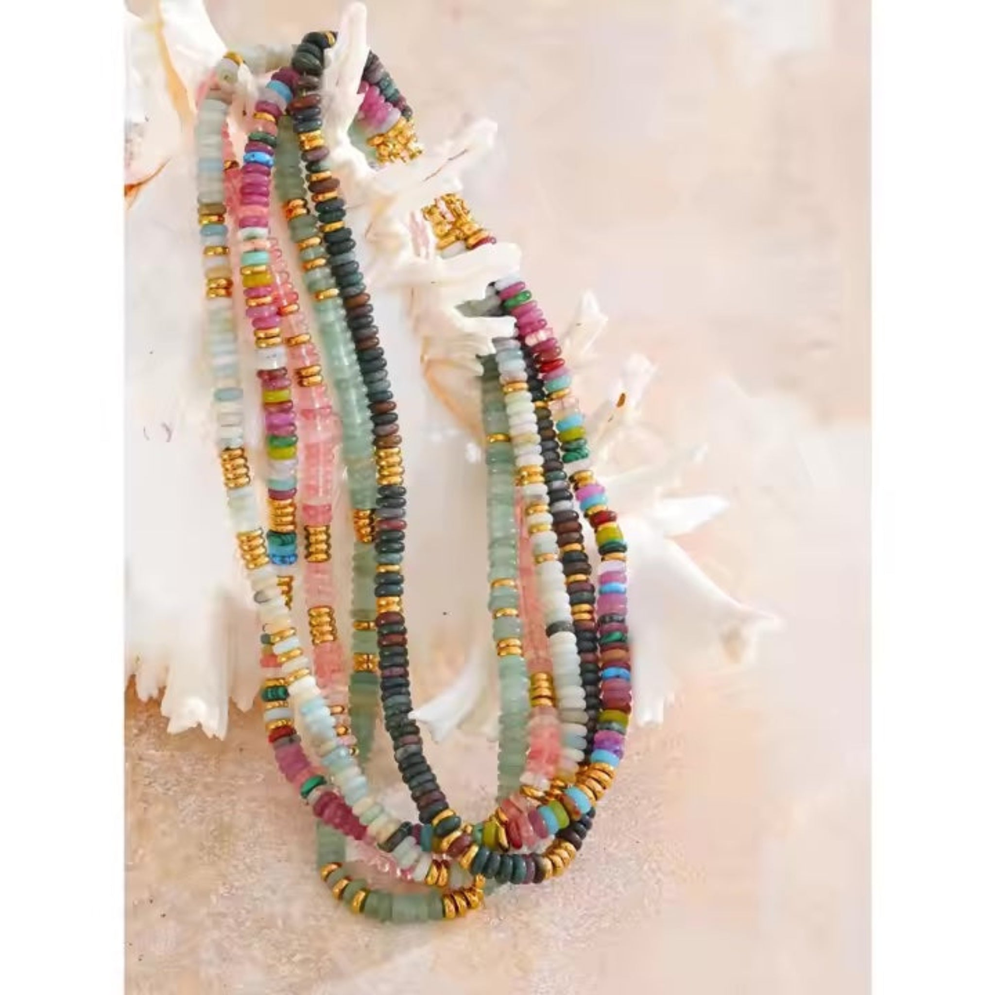 Colorful beaded necklaces on a white coral background