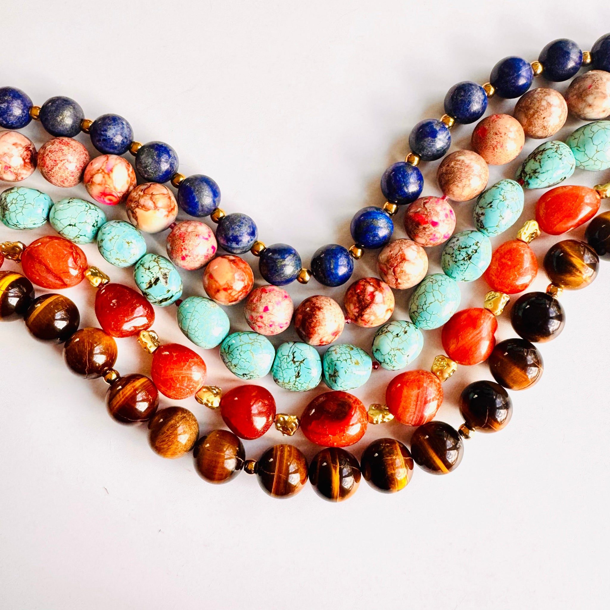 Colorful beaded necklaces on a white background