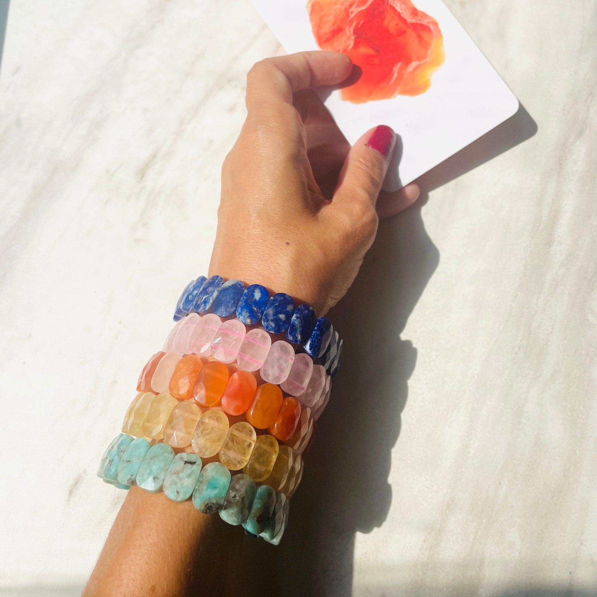 colorful gemstone bracelets on arm