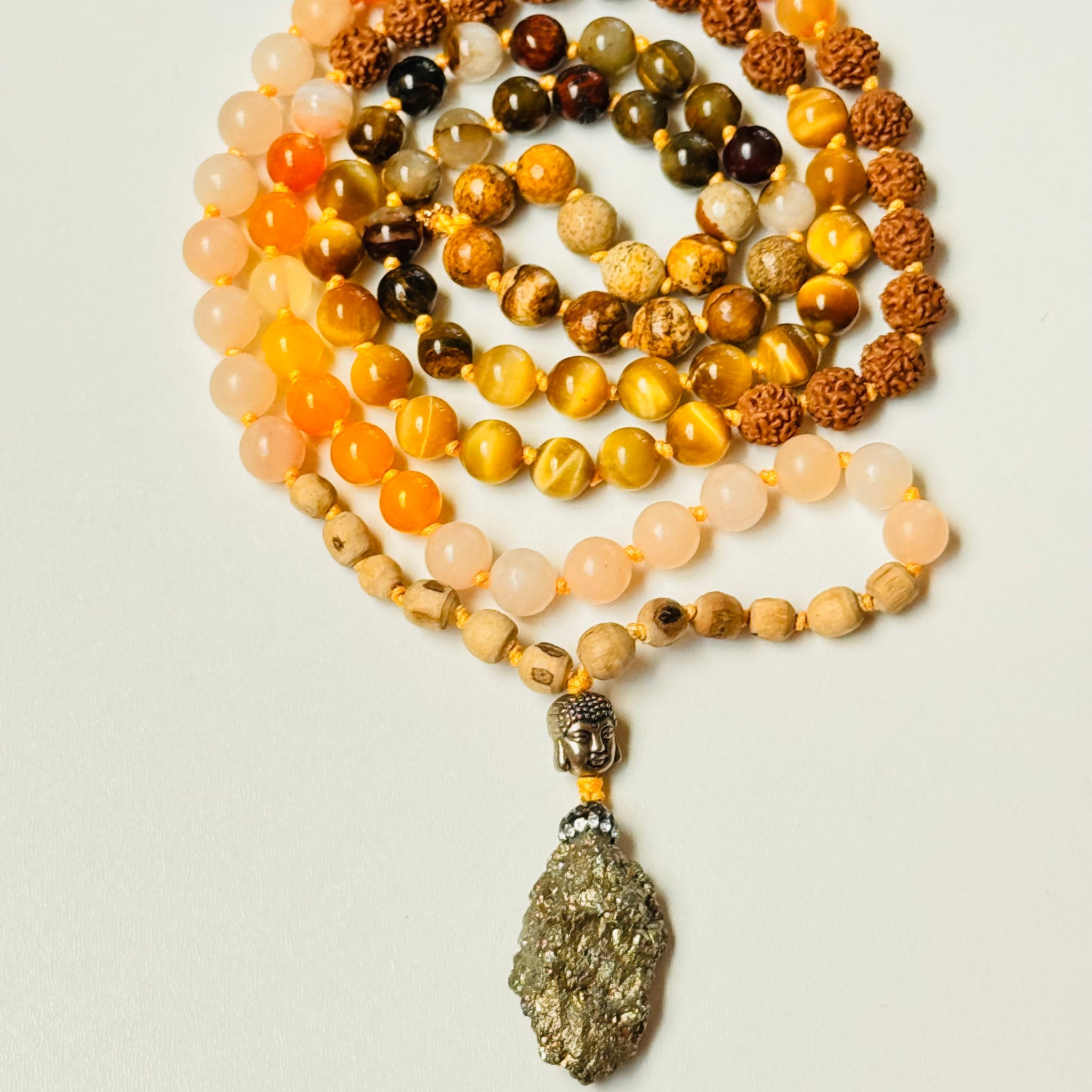 Necklace with multicolored beads and a large pendant on a light background