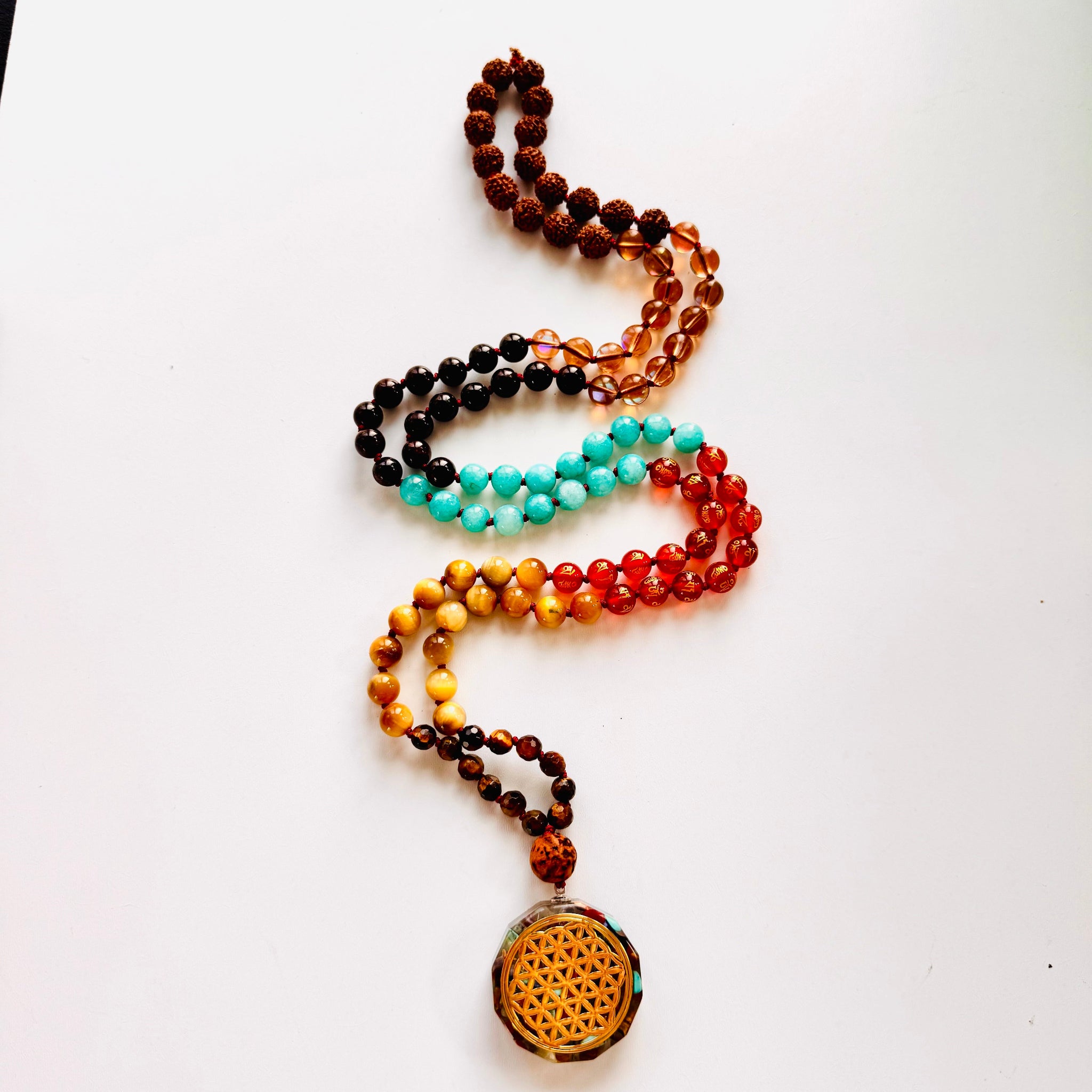 Colorful beaded necklace with a yellow pendant on a white background