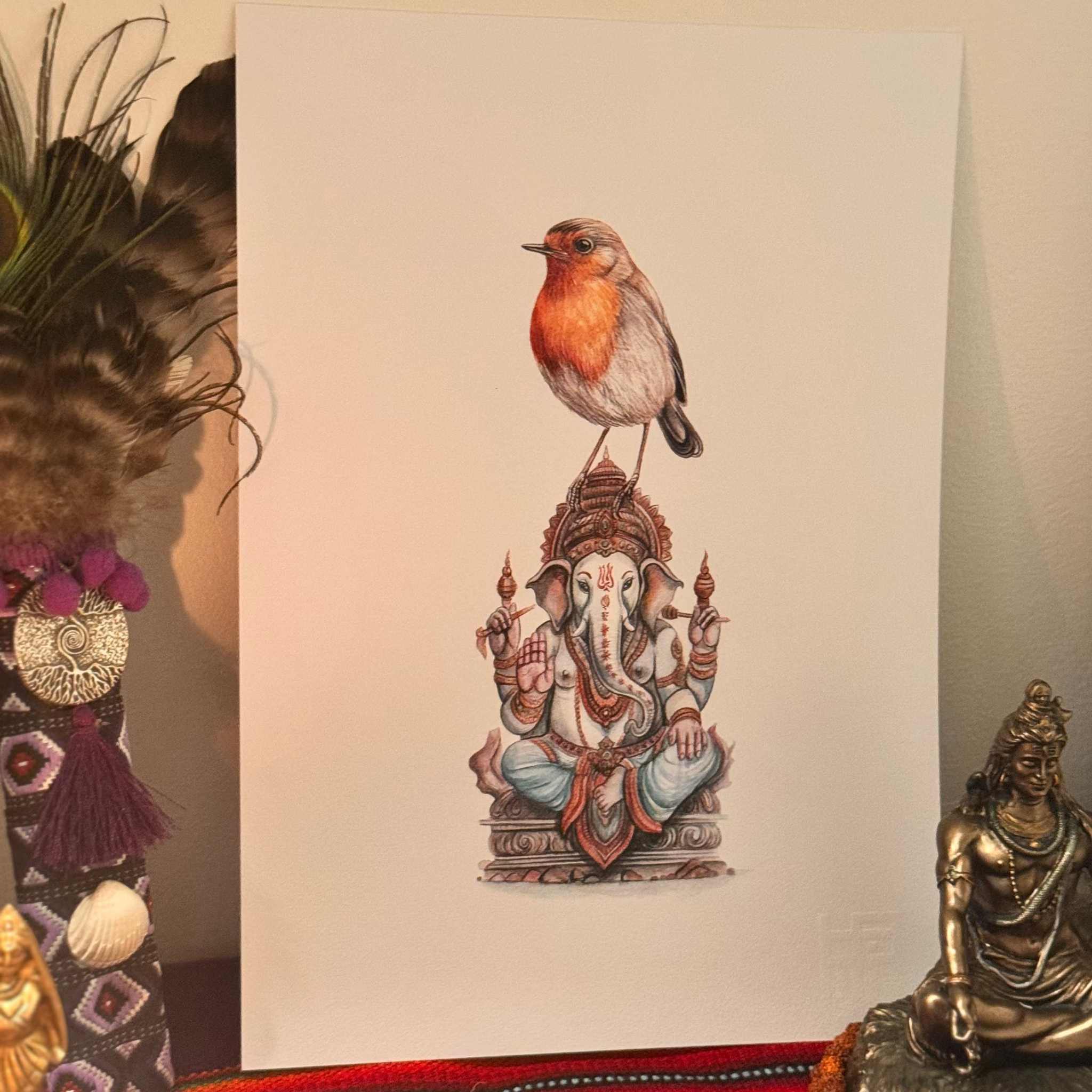 Illustration of a bird perched on a statue of Ganesha with decorative objects in the foreground.