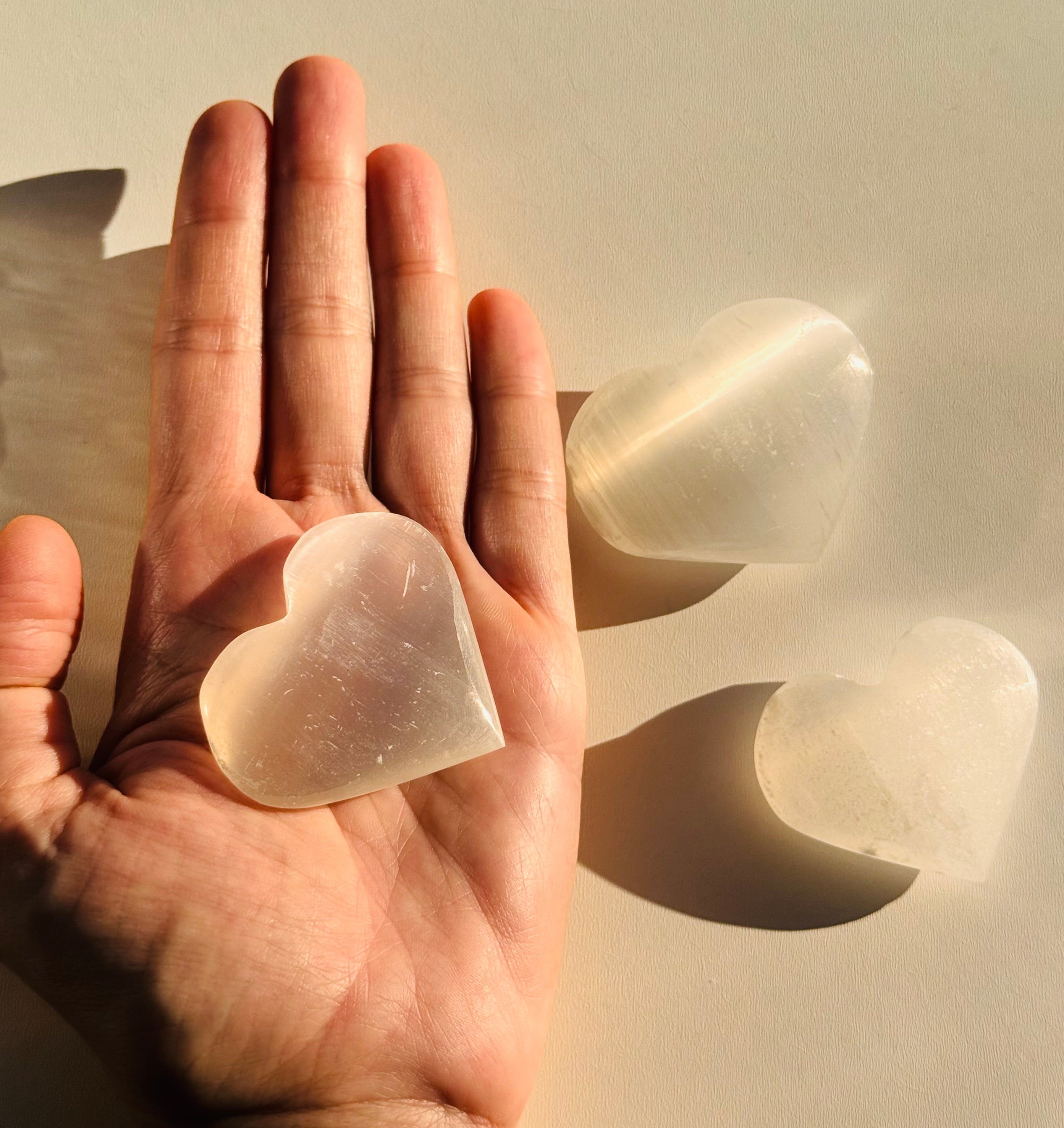 Hand holding a clear silicone gel pad against a neutral background