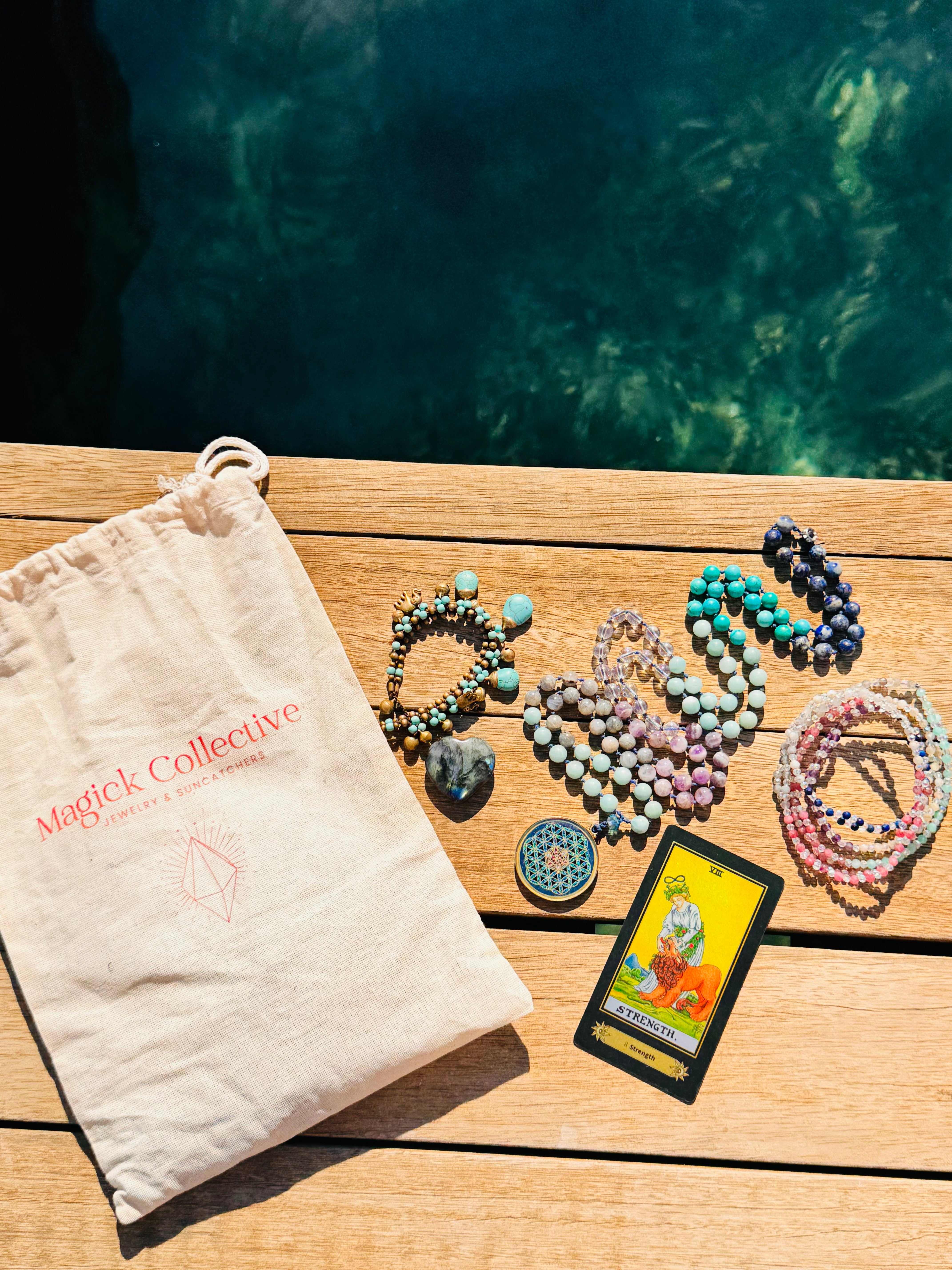 Delicate gold chain necklace featuring a blue crystal pendant displayed flat.