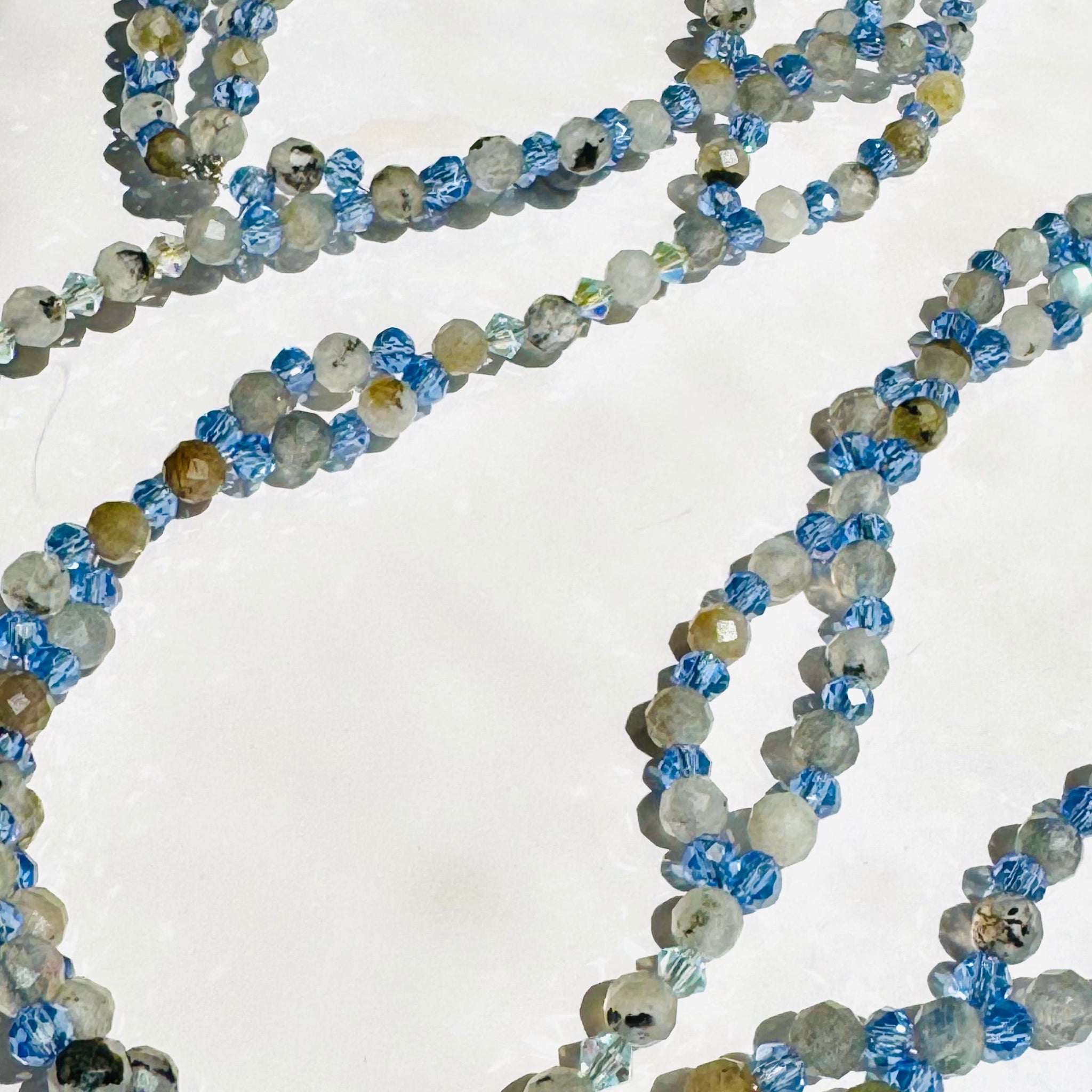 Beaded Moonstone tantric necklace on white surface closeup photo