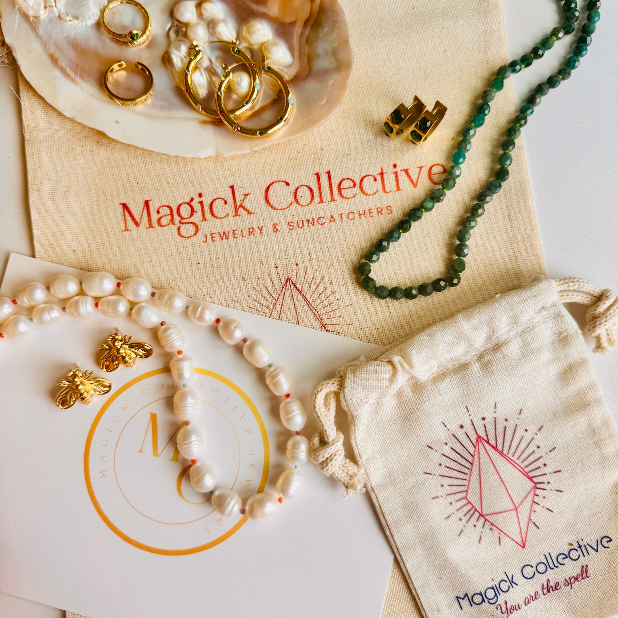 Jewelry set with 'Magick Collective' branding on packaging and jewelry.