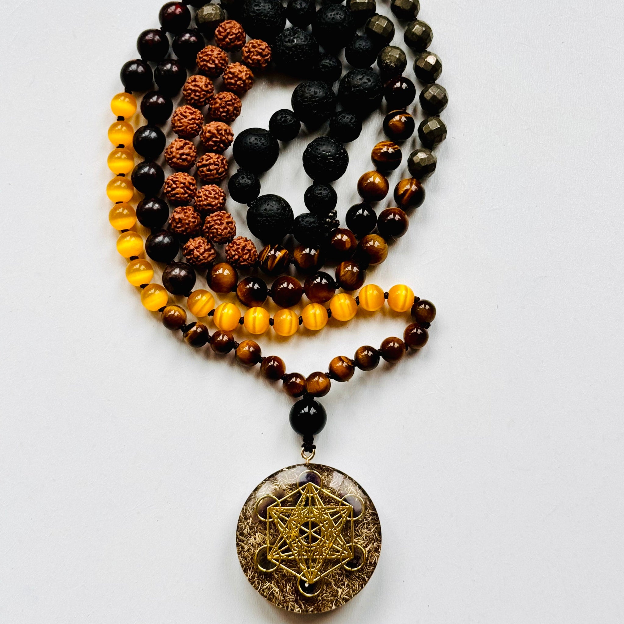 A beaded mala necklace with a Metatron's Cube pendant, featuring various colored beads and a gold-colored pendant.