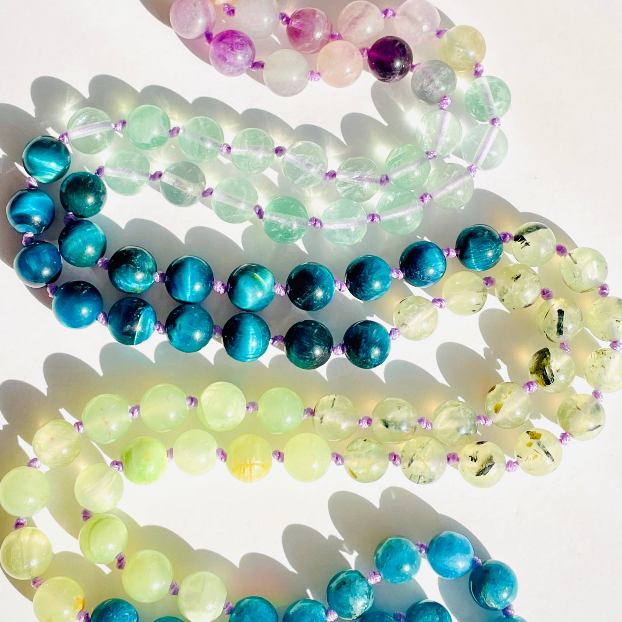Colorful beaded necklaces on a white background