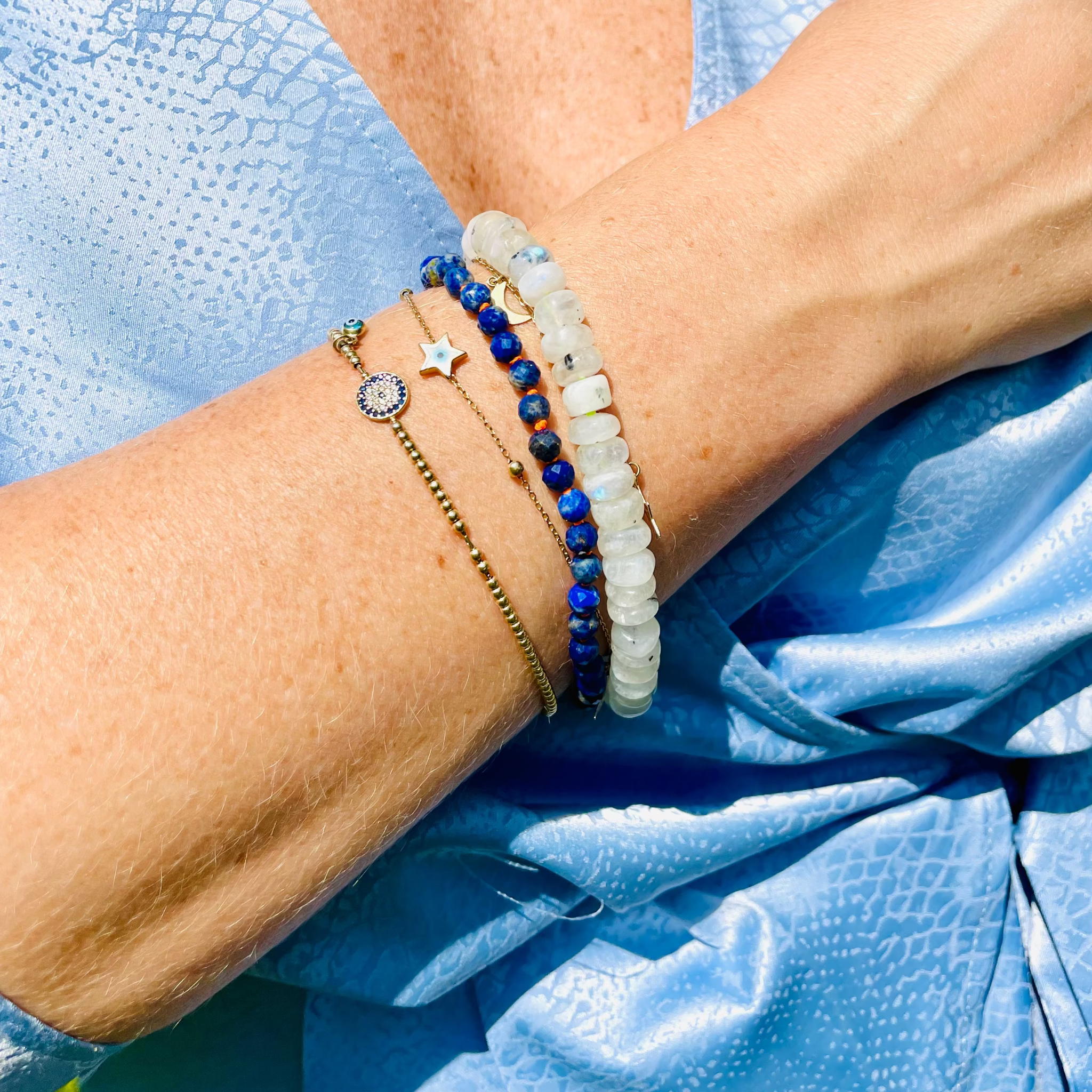 Beaded rainbow moonstone and lapis lazuli bracelet on model