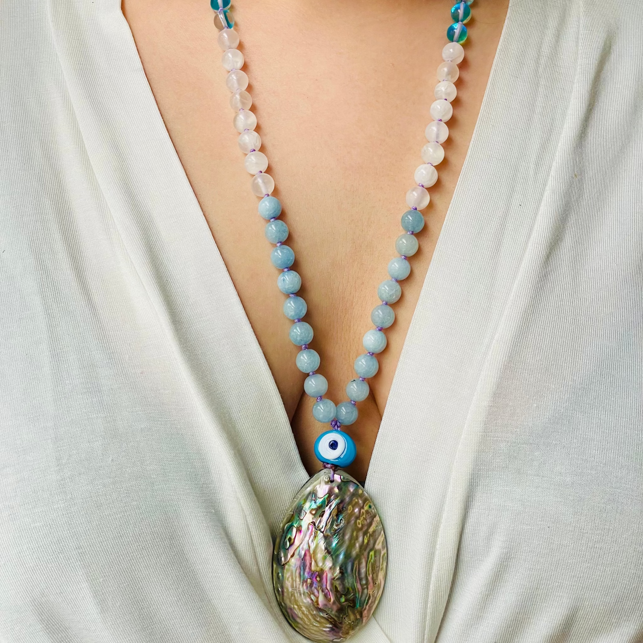 beaded gemstone necklace with shell pendant on model