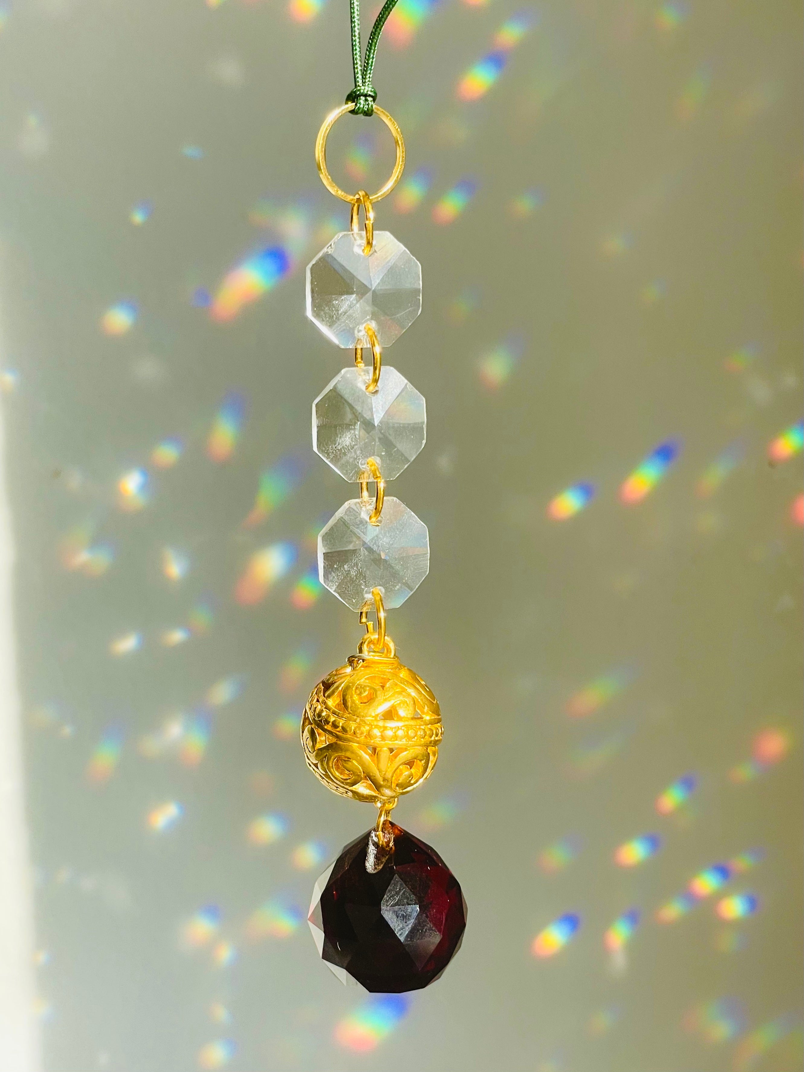 Red Ball Hanging Ornament in front of white surface