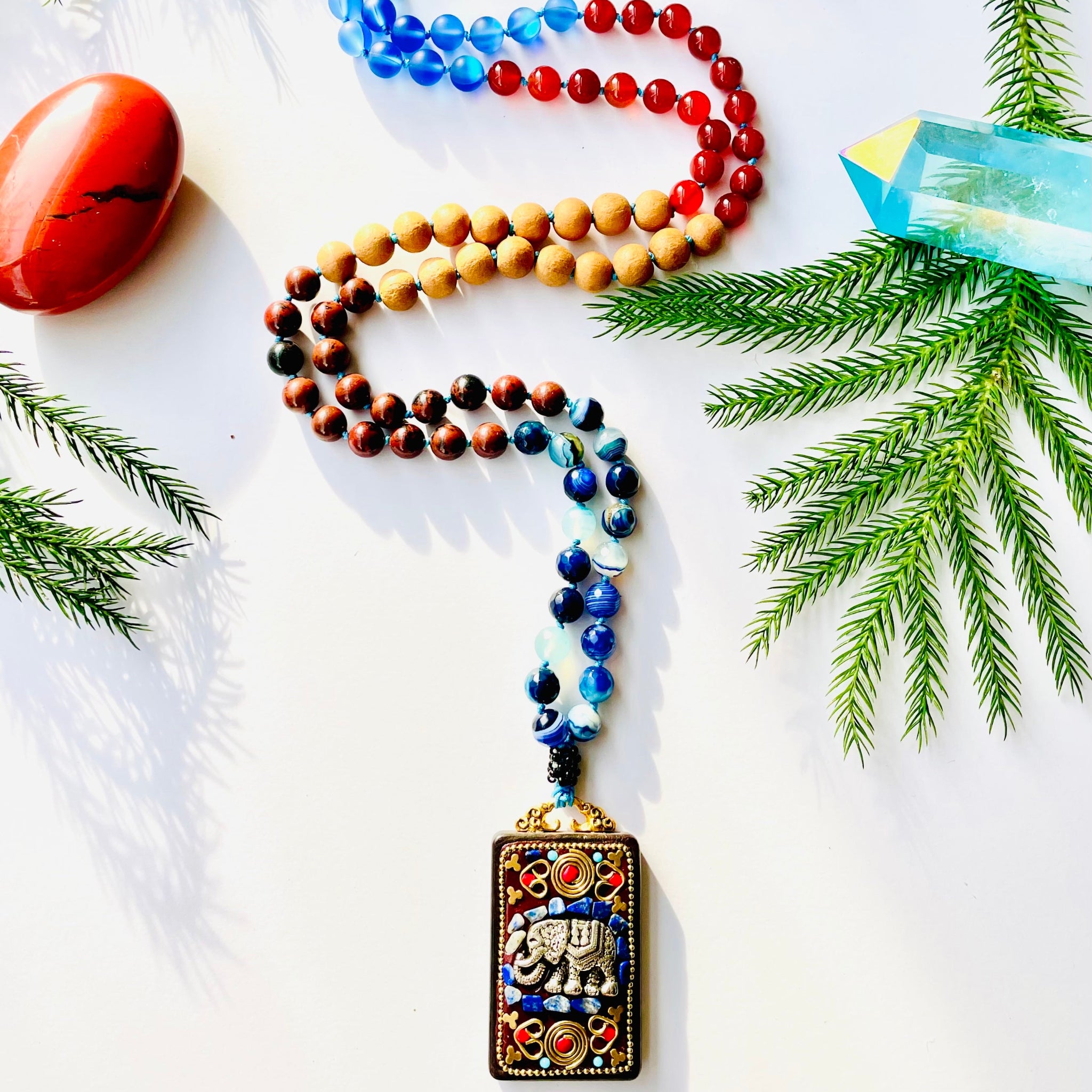 Rinn Harta Mala with pines and decorative crystals