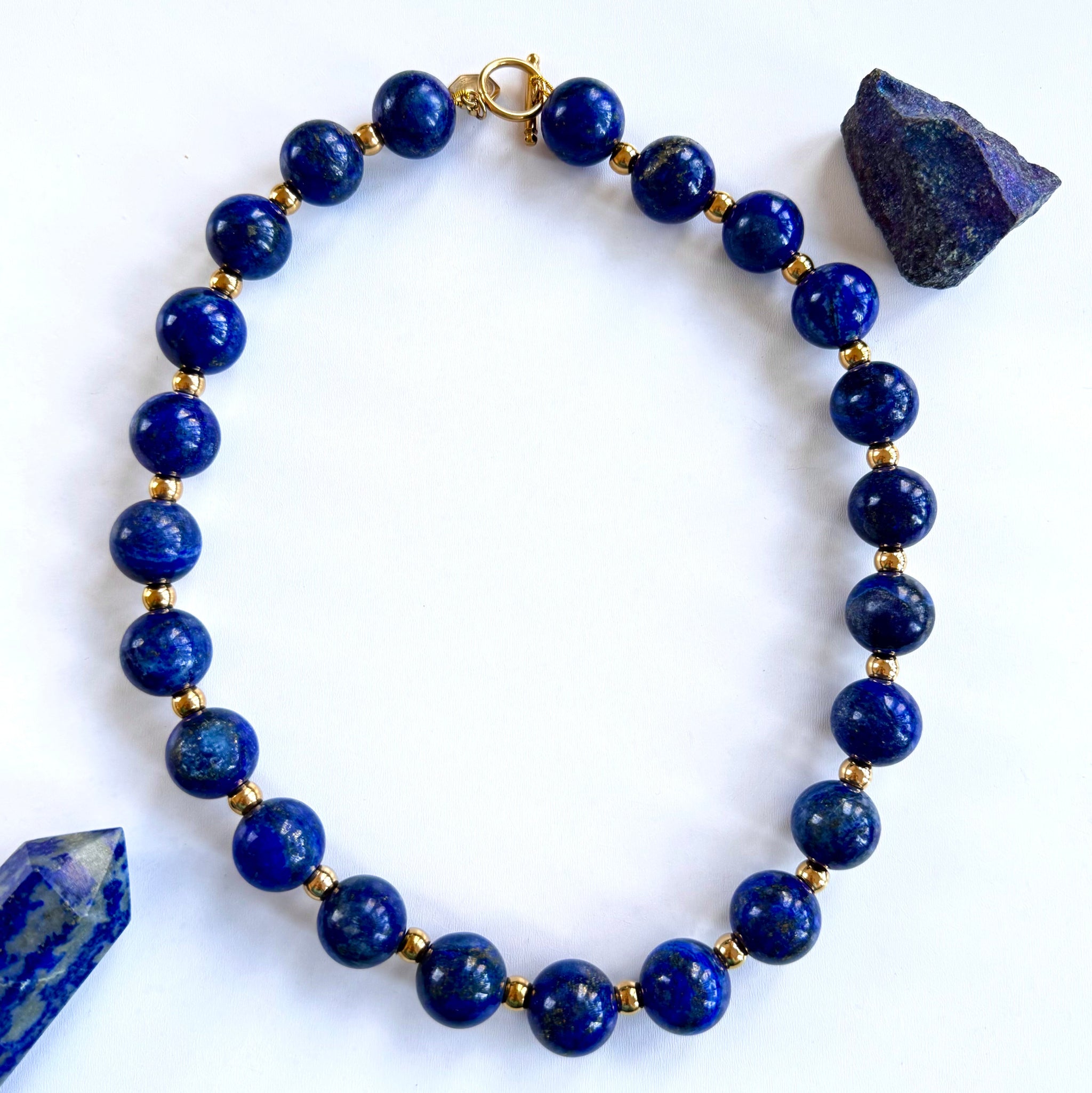A necklace with spherical blue lapis lazuli beads and two larger, rough-cut lapis lazuli pieces