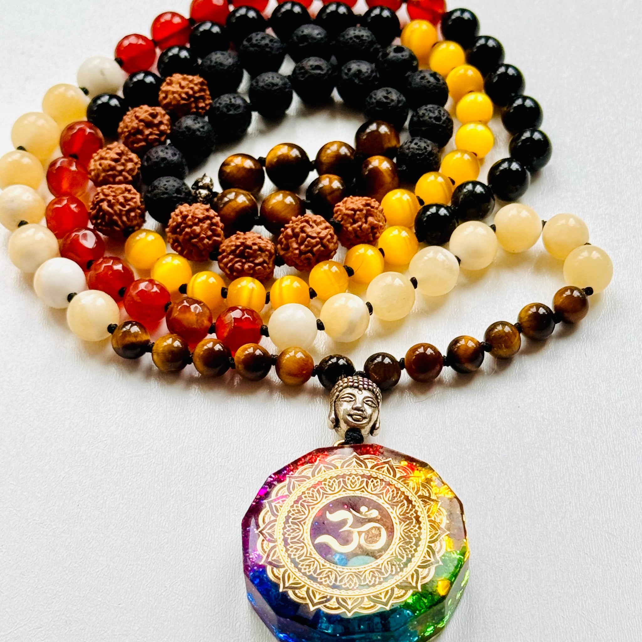 A variety of colorful gemstone beads with Om orgonite pendant.
