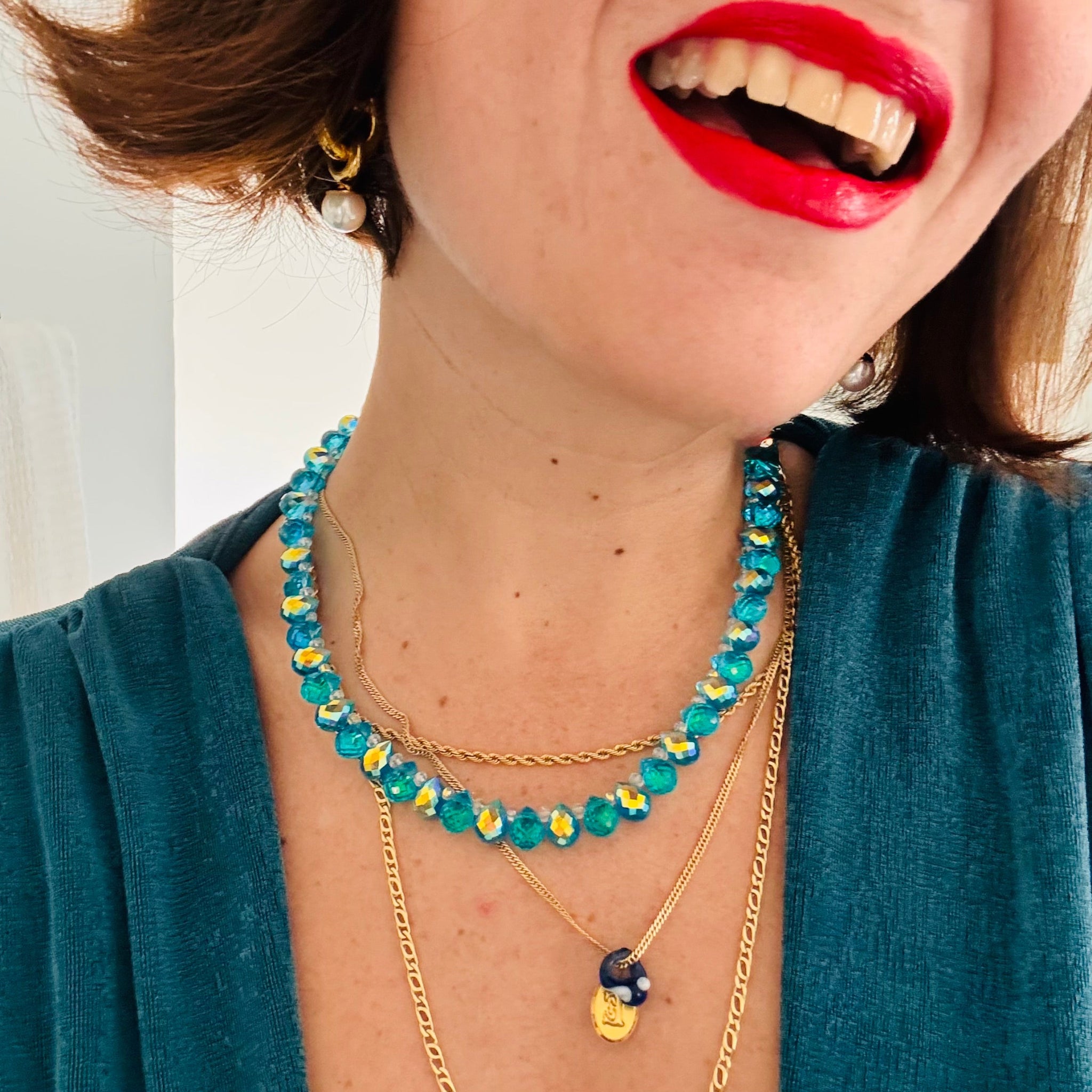 blue necklace wearing model