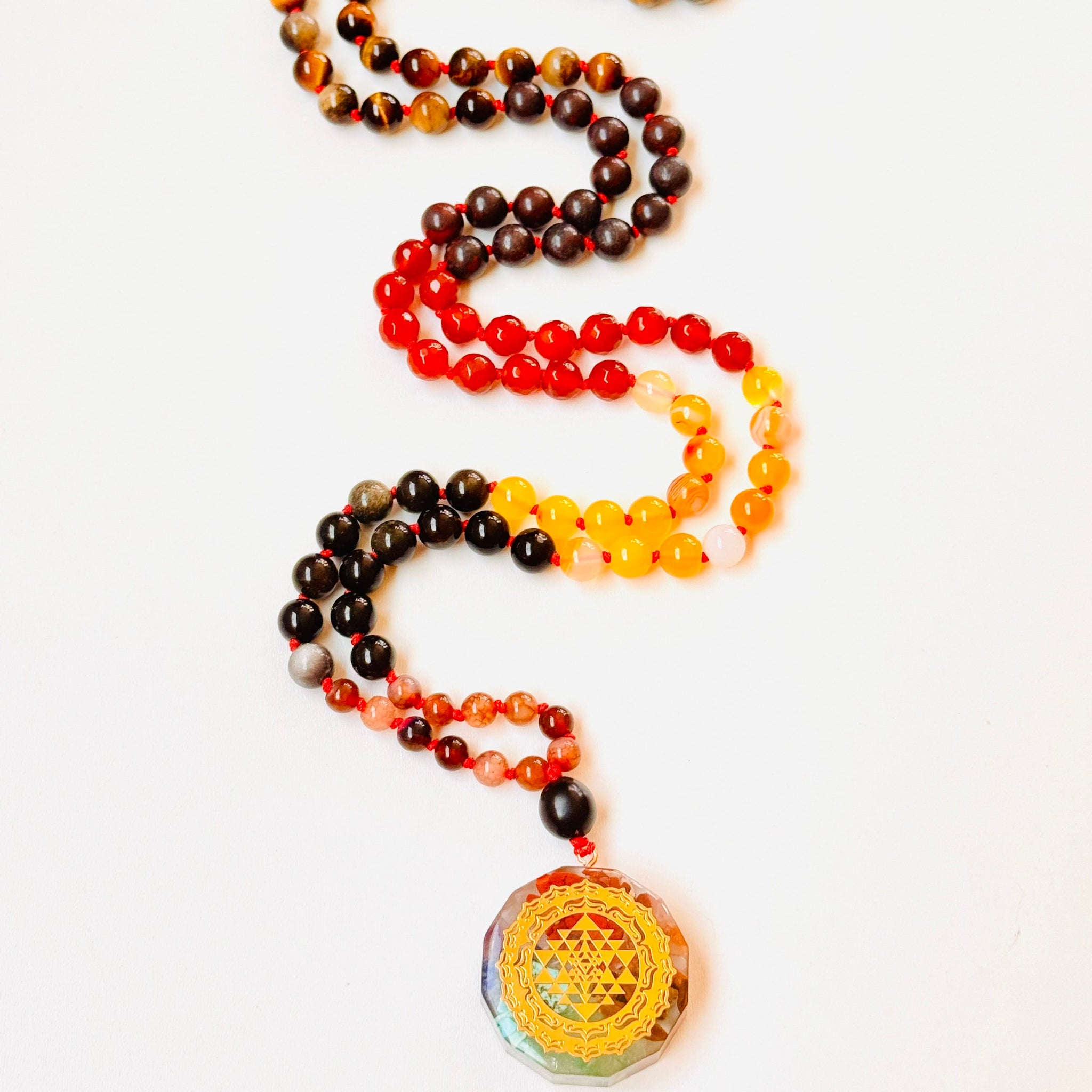 Colorful beaded necklace with a pendant on a white background