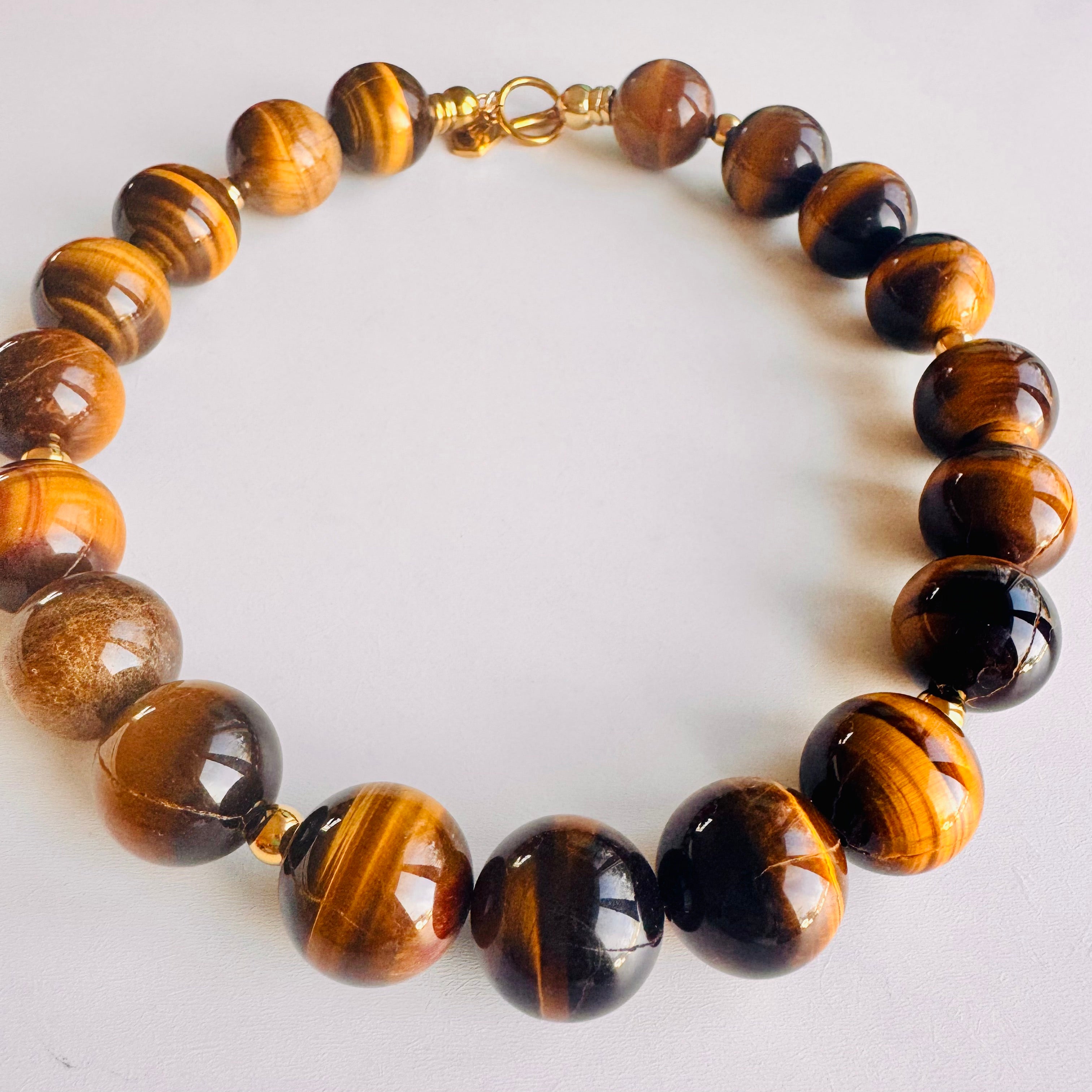 Necklace with tiger eye stones on a white background