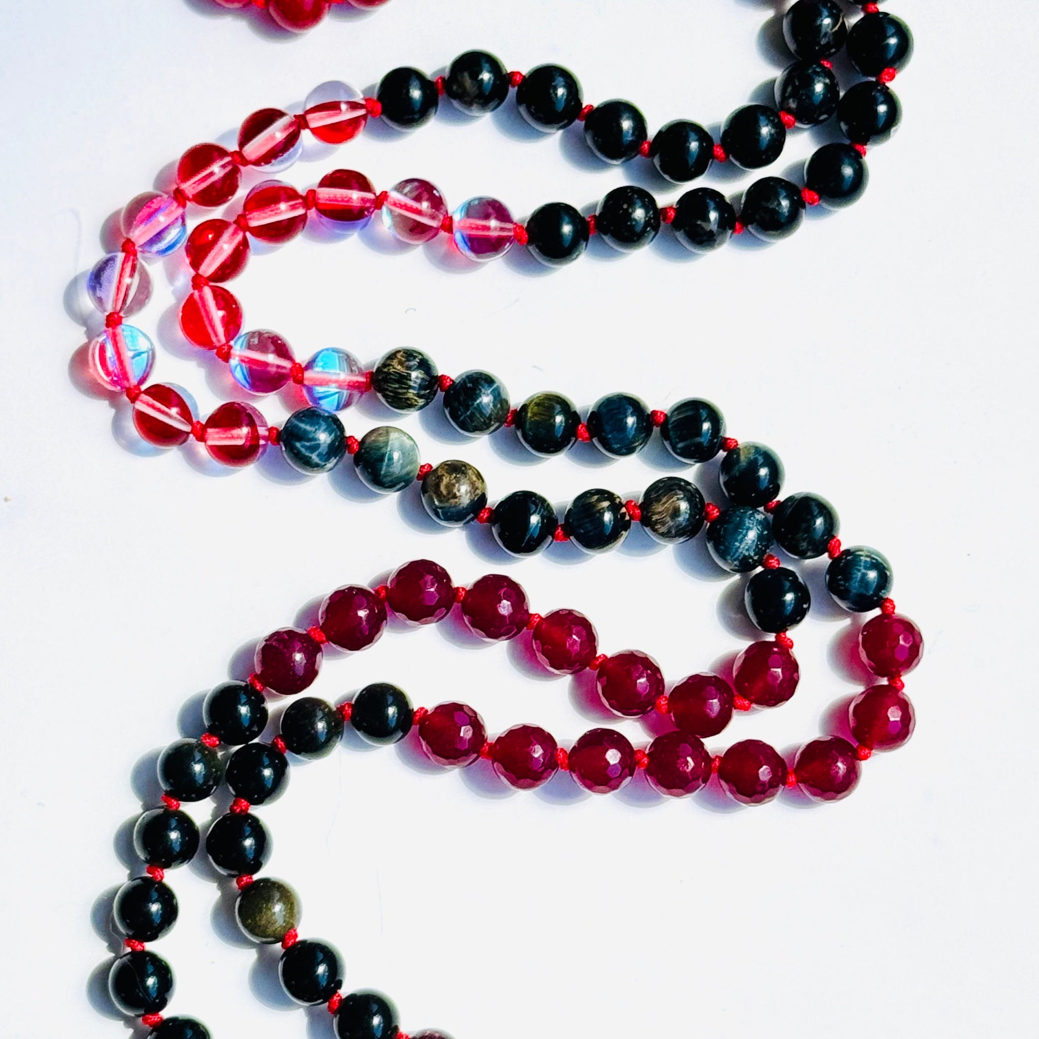 Transformation mala beads red and black closeup image