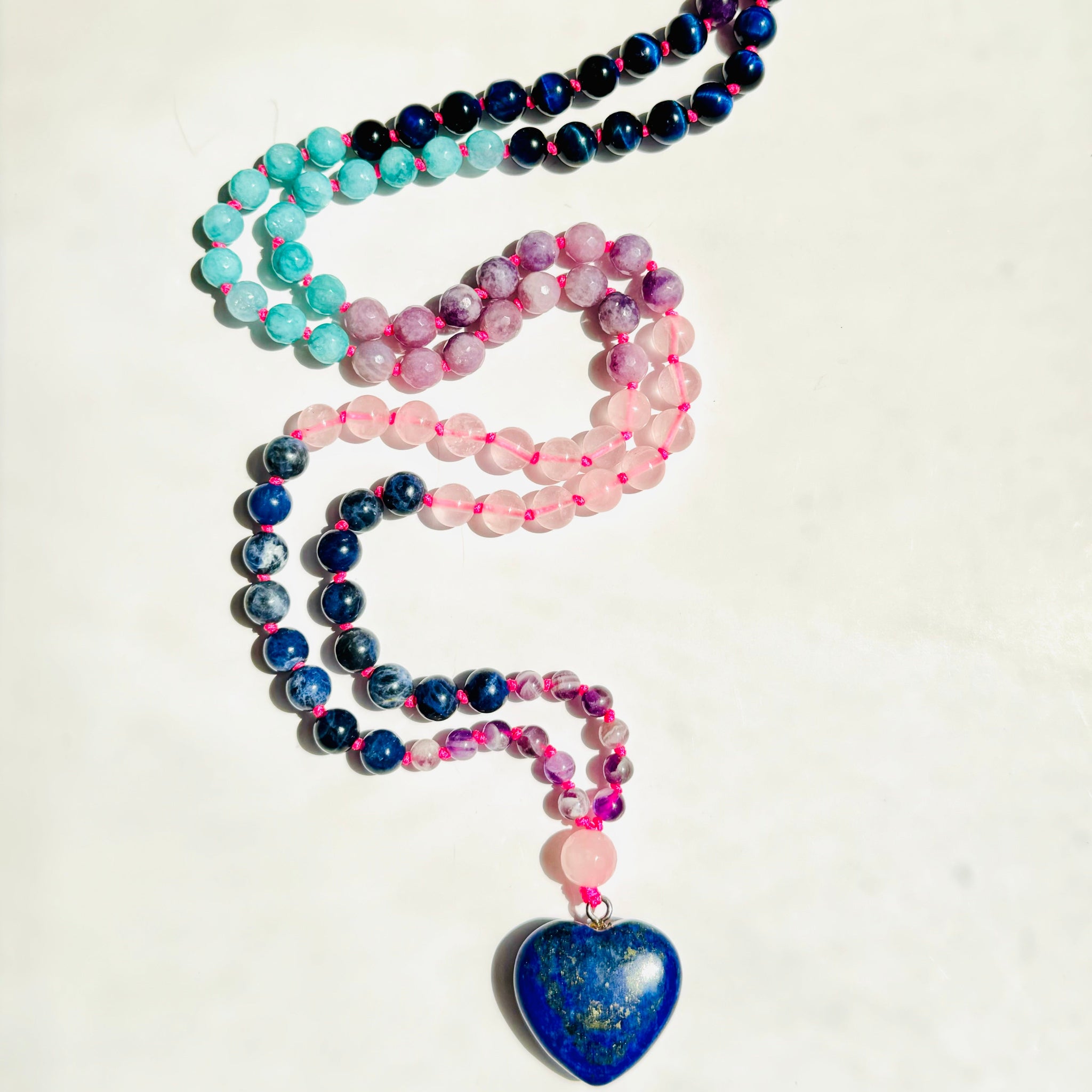 beaded blue and pink gemstone mala with blue heart shaped pendant