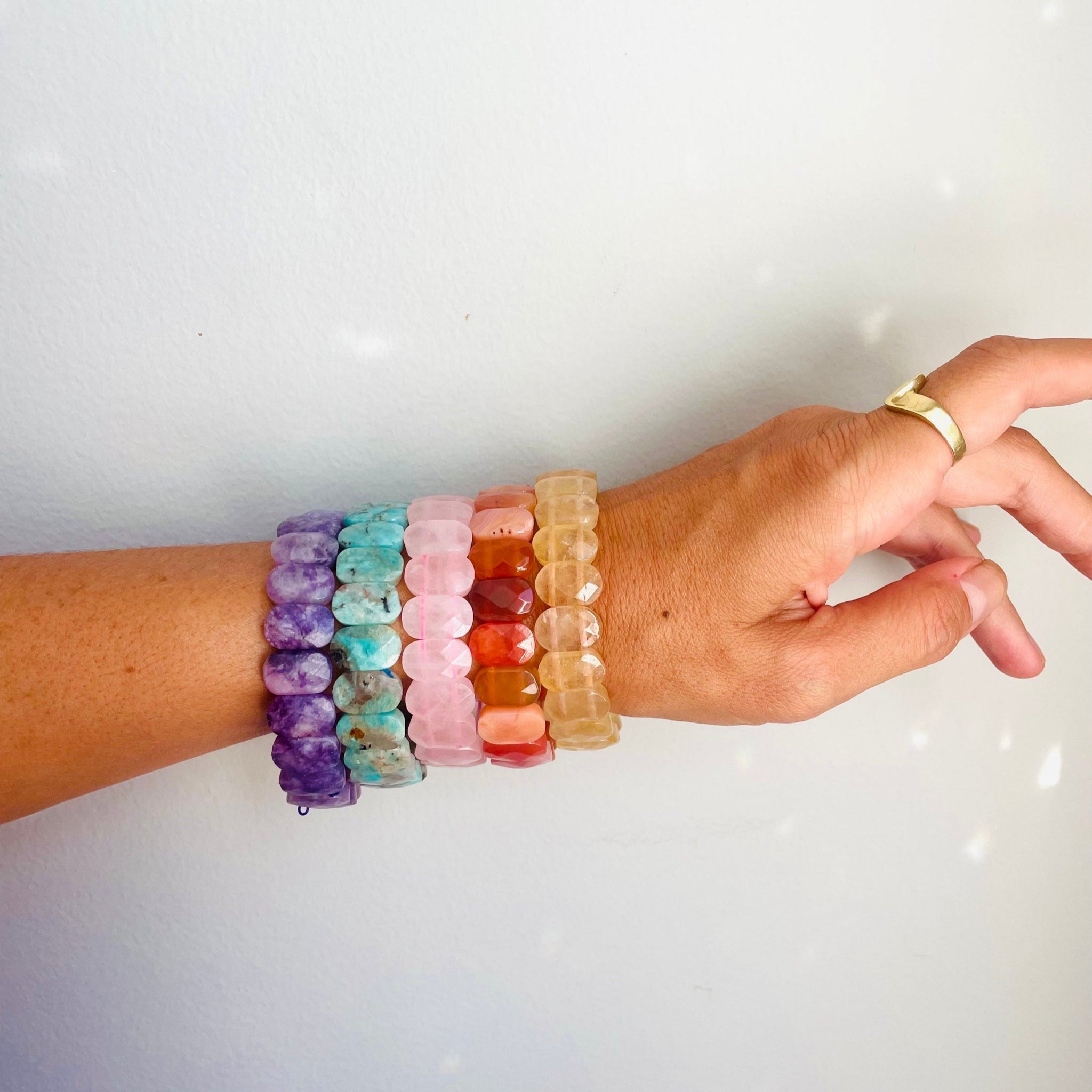 colorful gemstone bracelets on model