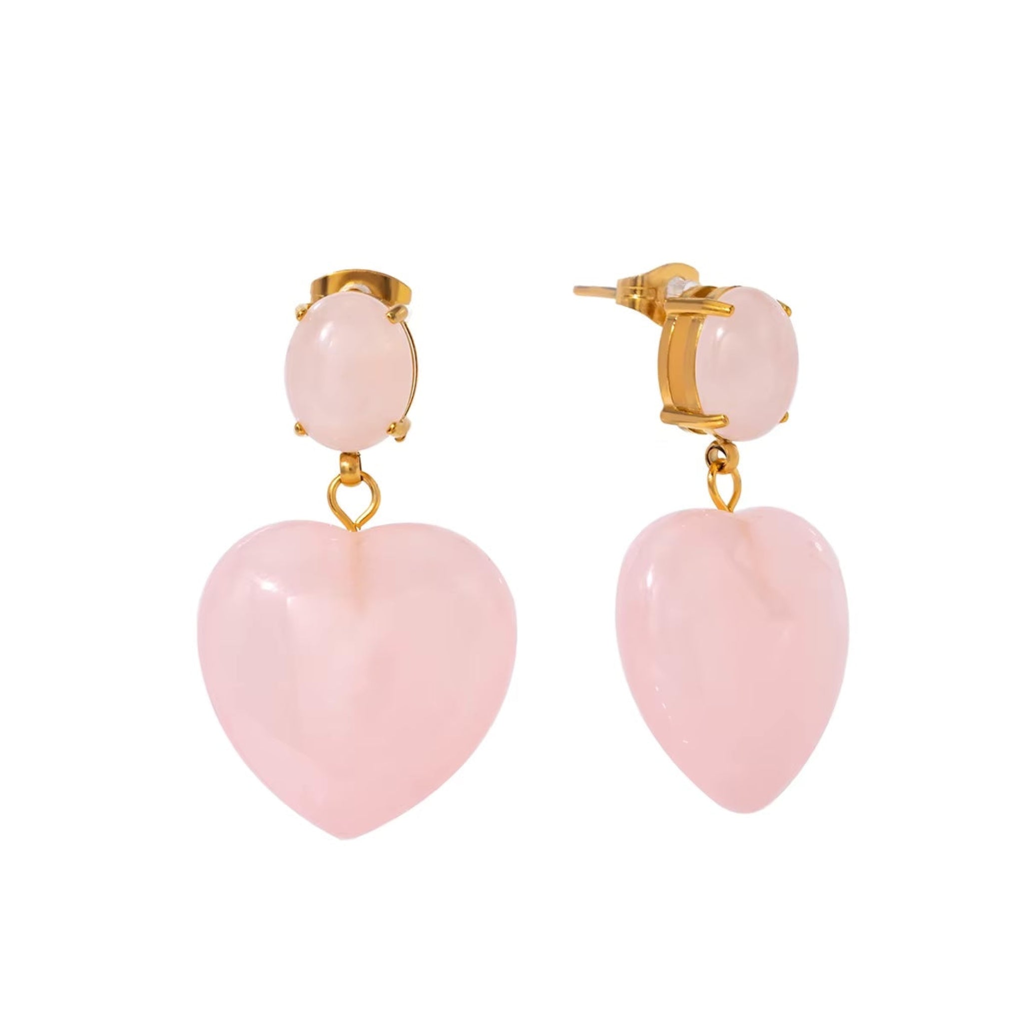 A pair of rose gold-colored heart-shaped drop earrings with oval-cut rose quartz studs, suspended from a butterfly backing.