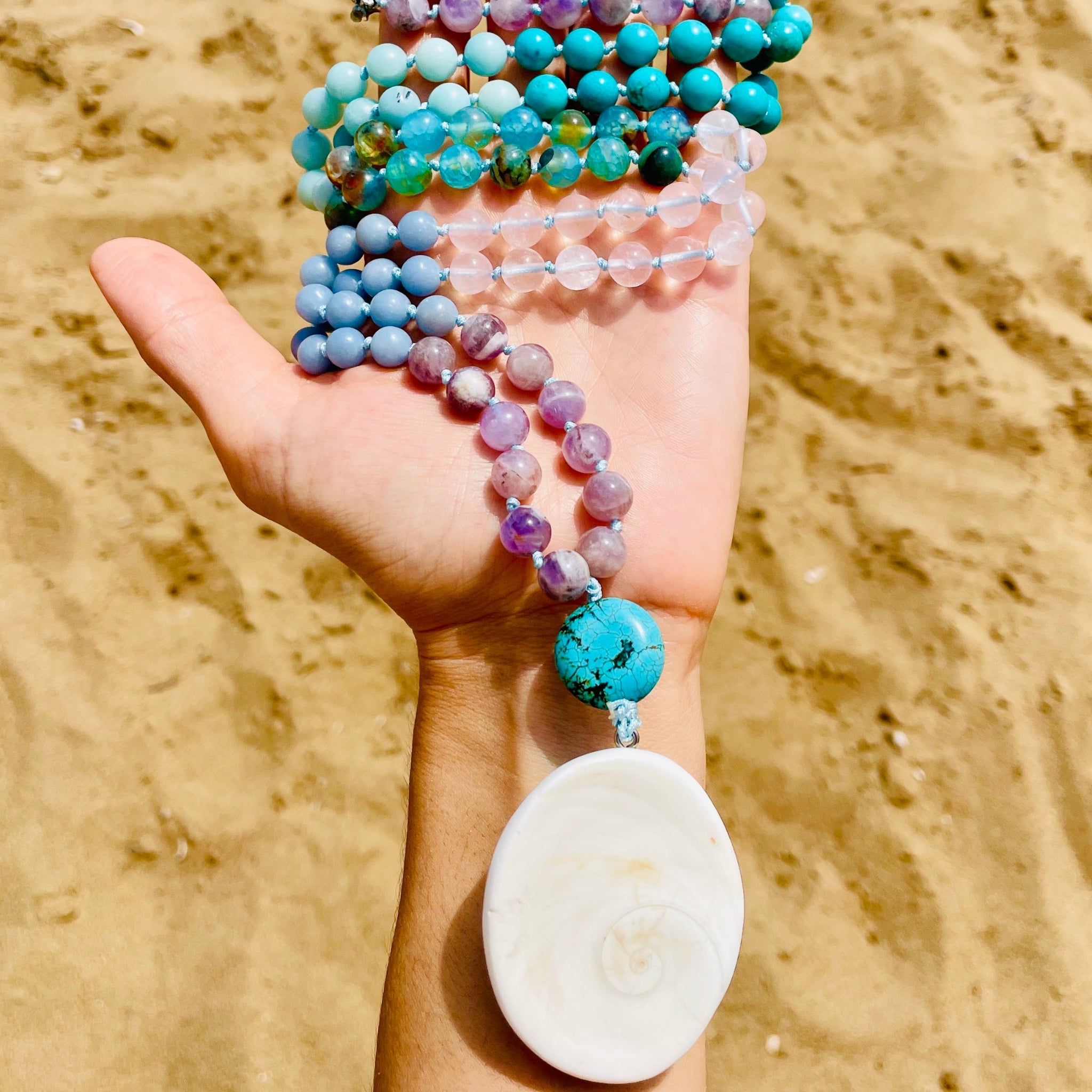 Closeup photo of eternal mala with sand background
