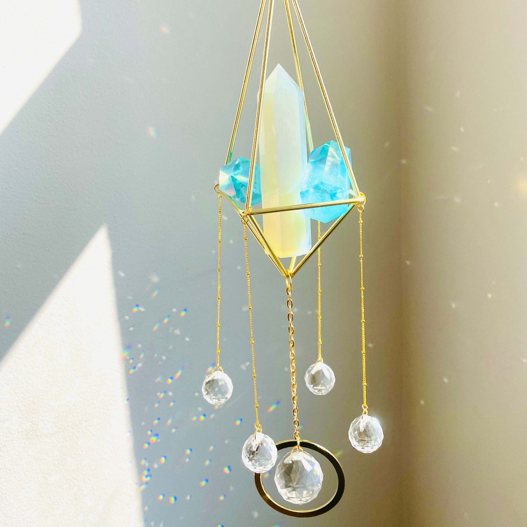 Opal Tower Suncatcher with prisms making rainbow reflections