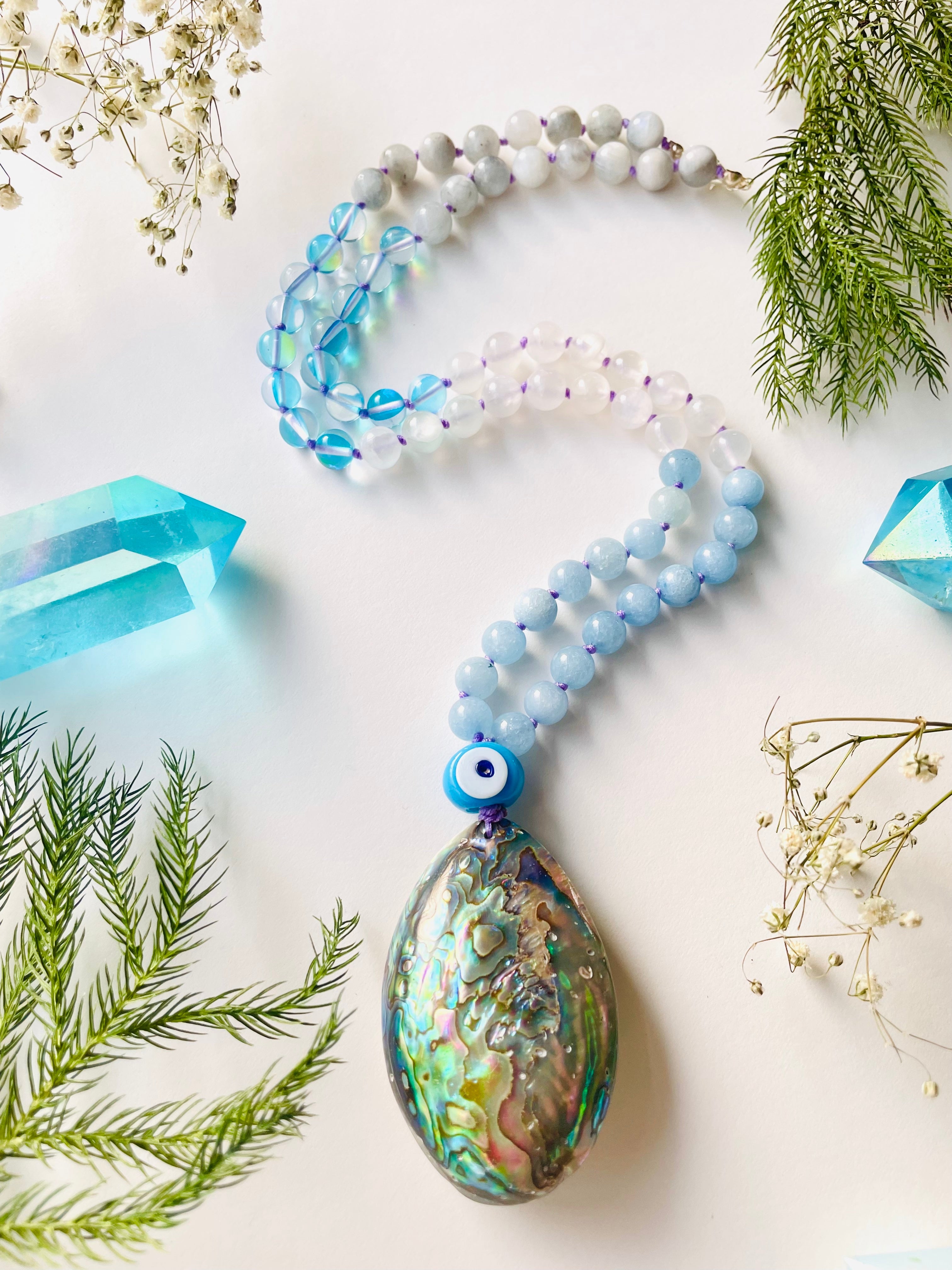 Beaded blue gemstone necklace with shell pendant