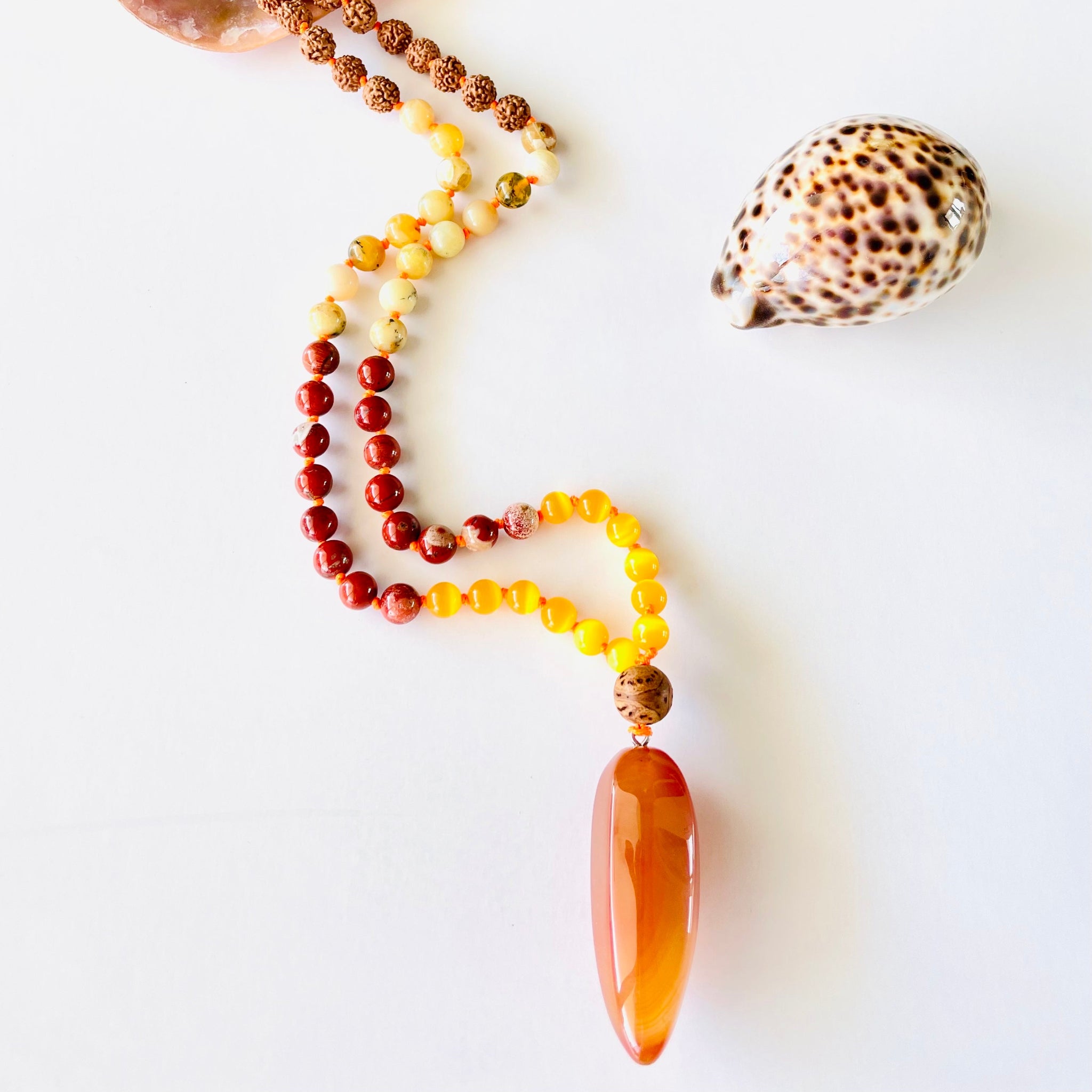 Beaded gemstone with decorative shell
