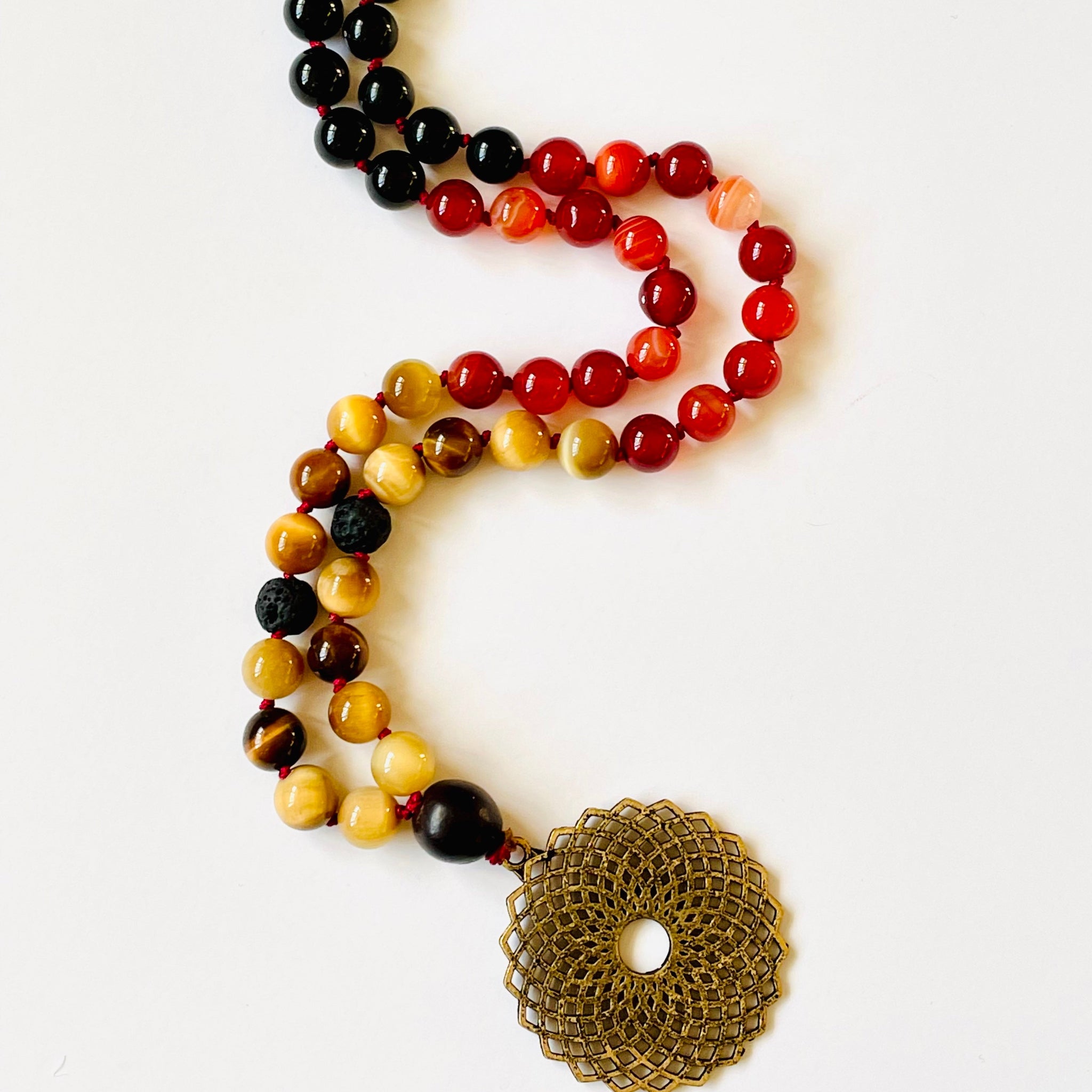 Necklace with multicolored beads and a large decorative clasp on a white background