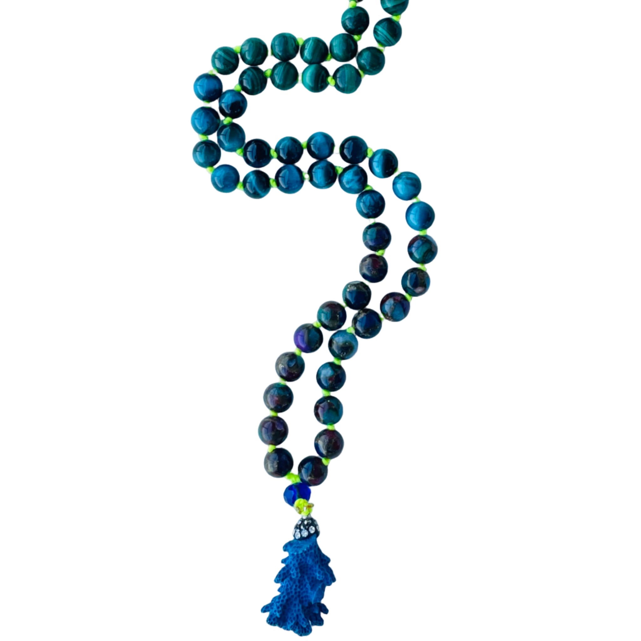 Beaded blue and green gemstones with blur coral pendant on white surface