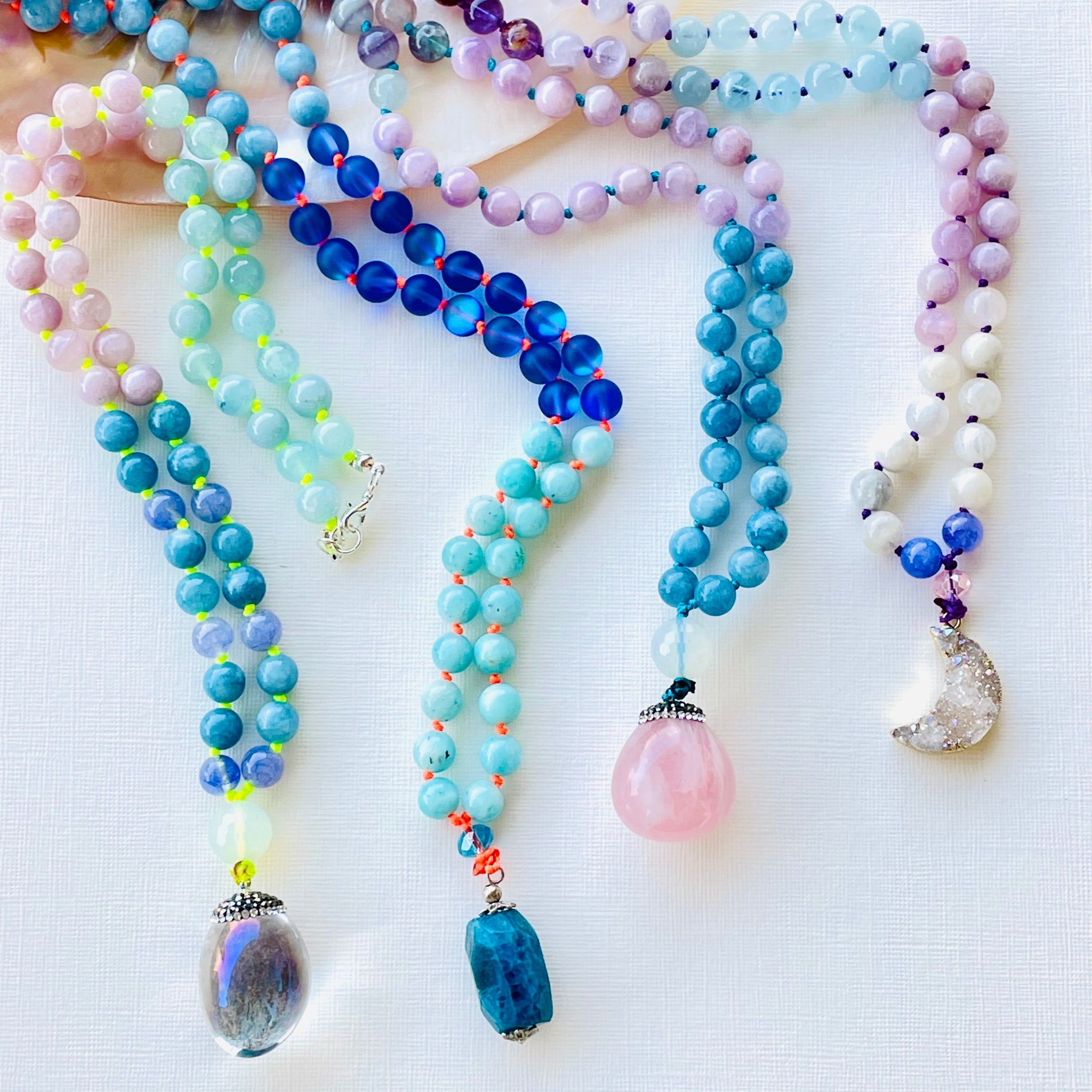 colorful necklaces on white surface