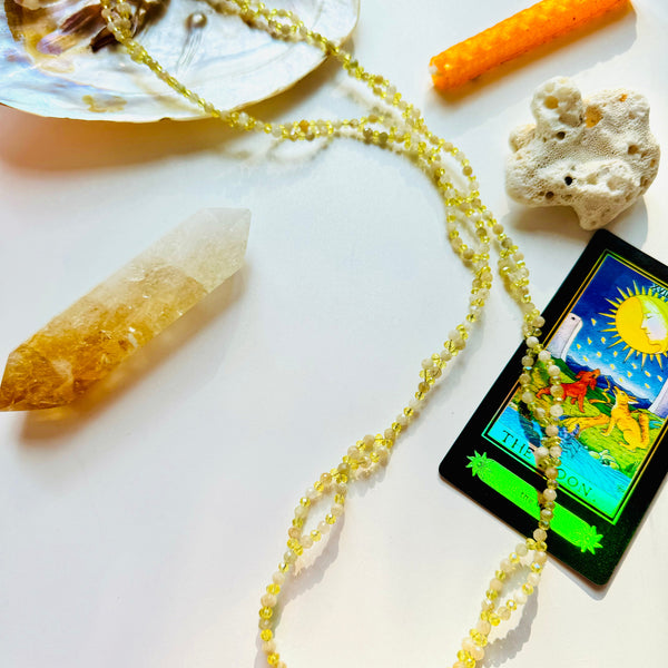 Citrine tantric necklace with decorative arcana card, citrine crystal, orange candle and seashell