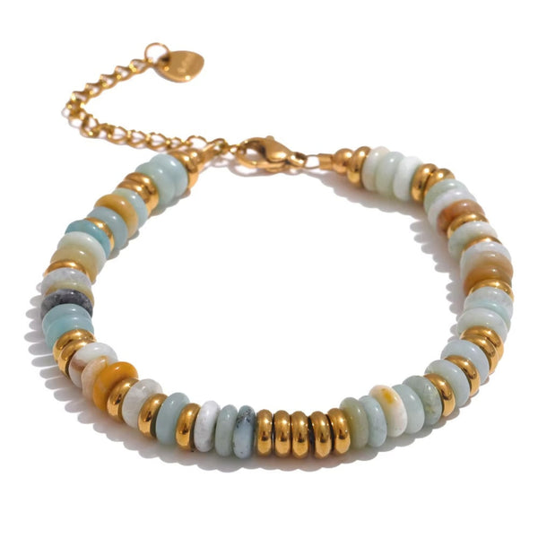 Bracelet with gold and white beads on a white background