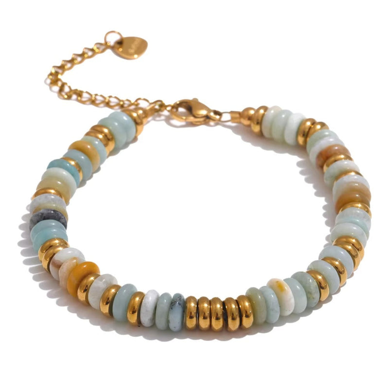 Bracelet with gold and white beads on a white background