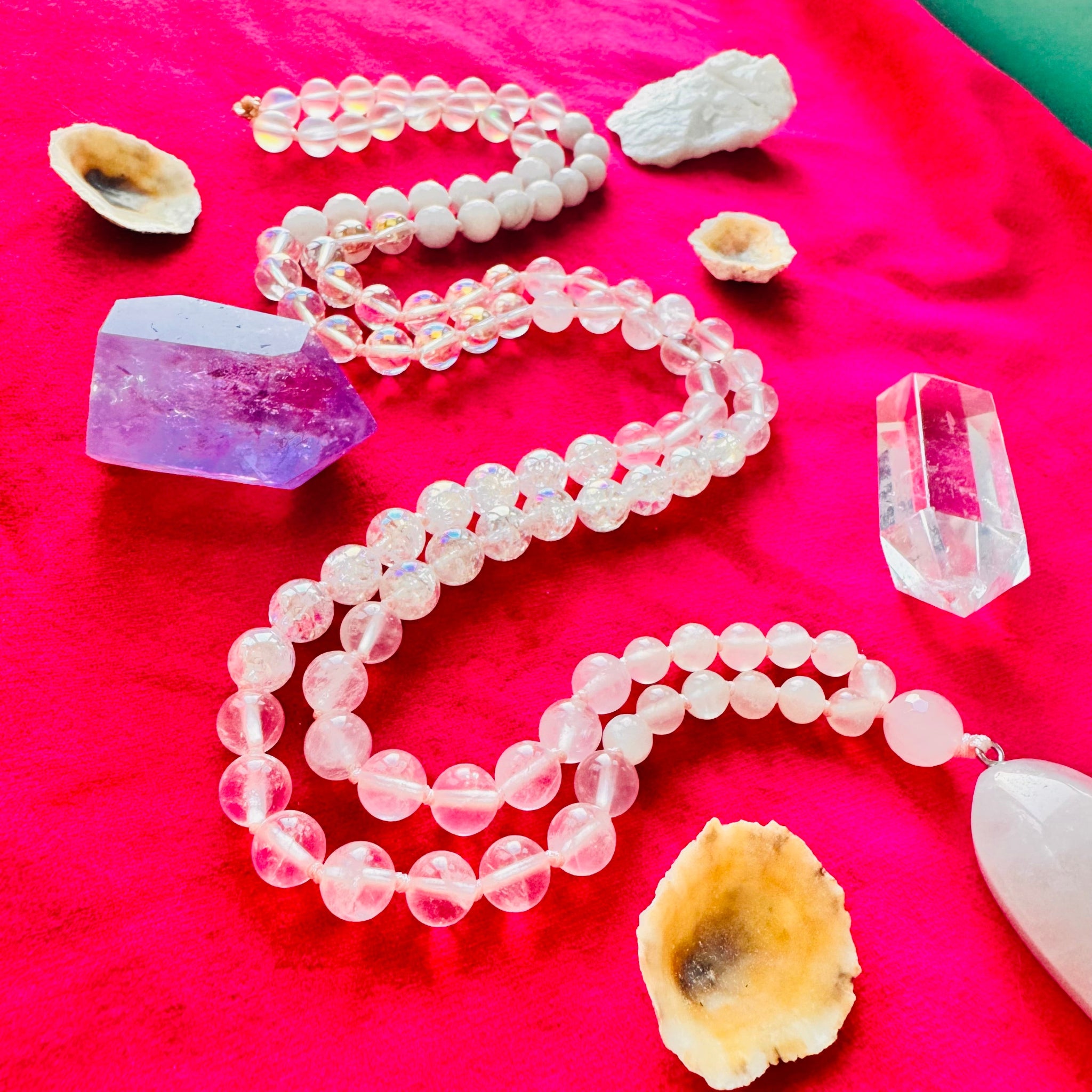 Pink beaded necklace with crystals and shells on a pink background