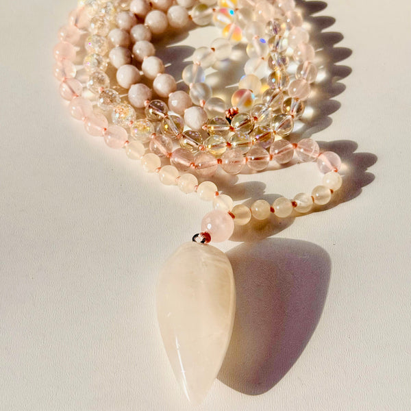 A handcrafted Angel Mala with 108 natural gemstone beads and a clear quartz pendant, designed for meditation and spiritual practices.