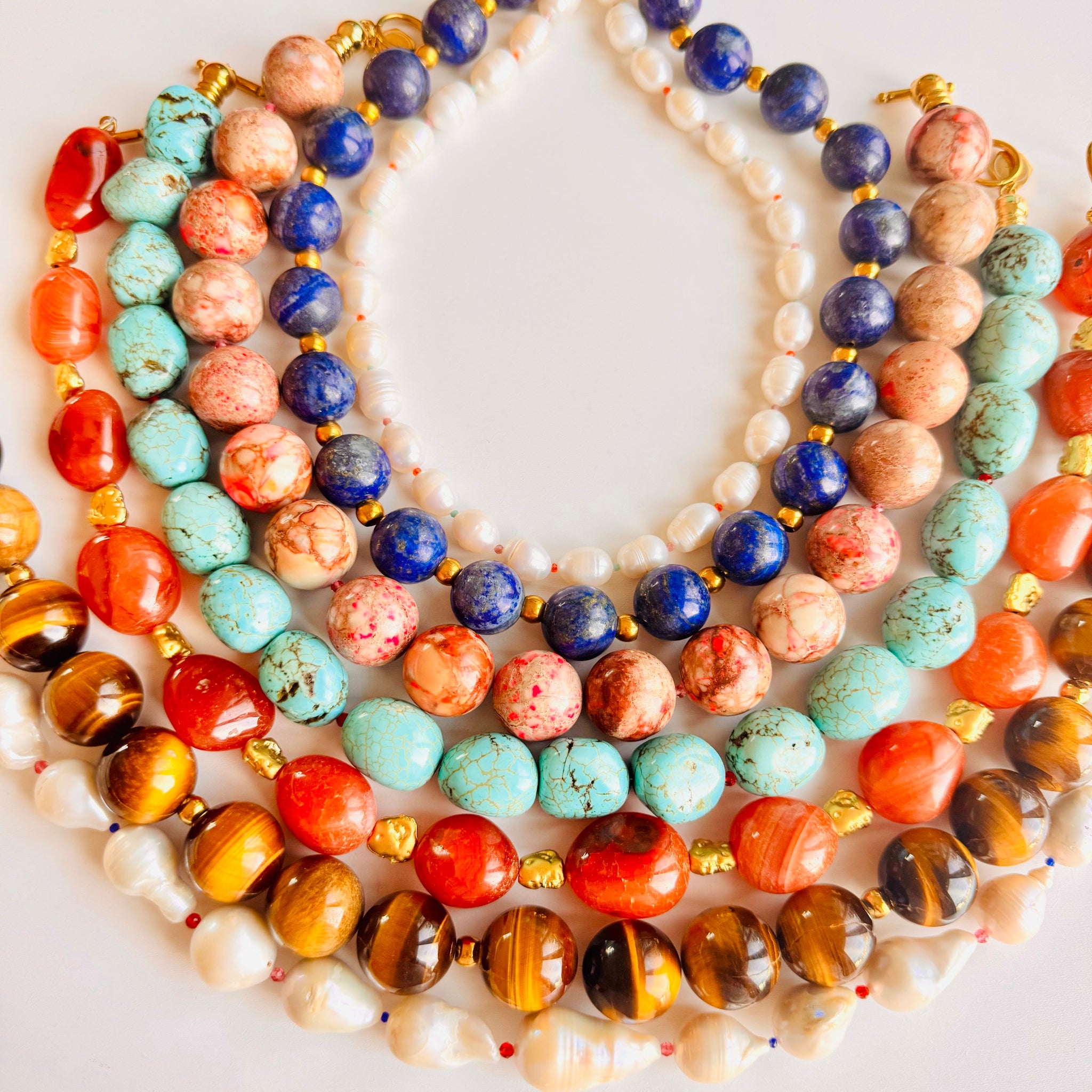 Colorful beaded necklaces on a white background