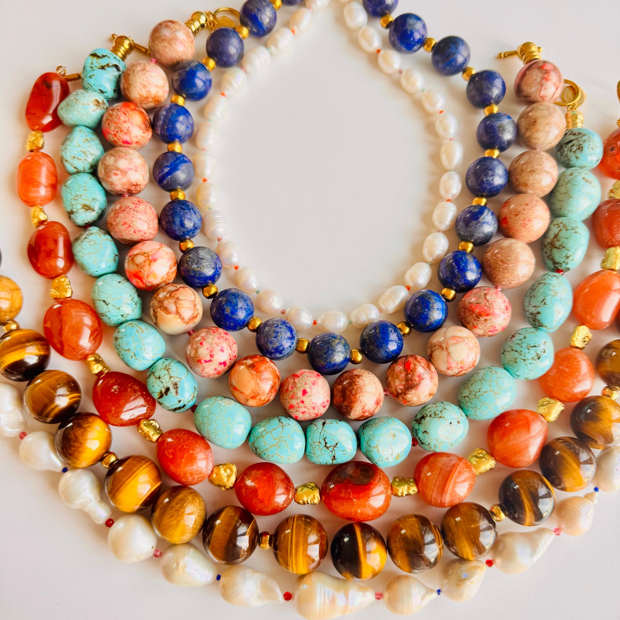 Colorful beaded necklaces on a white background