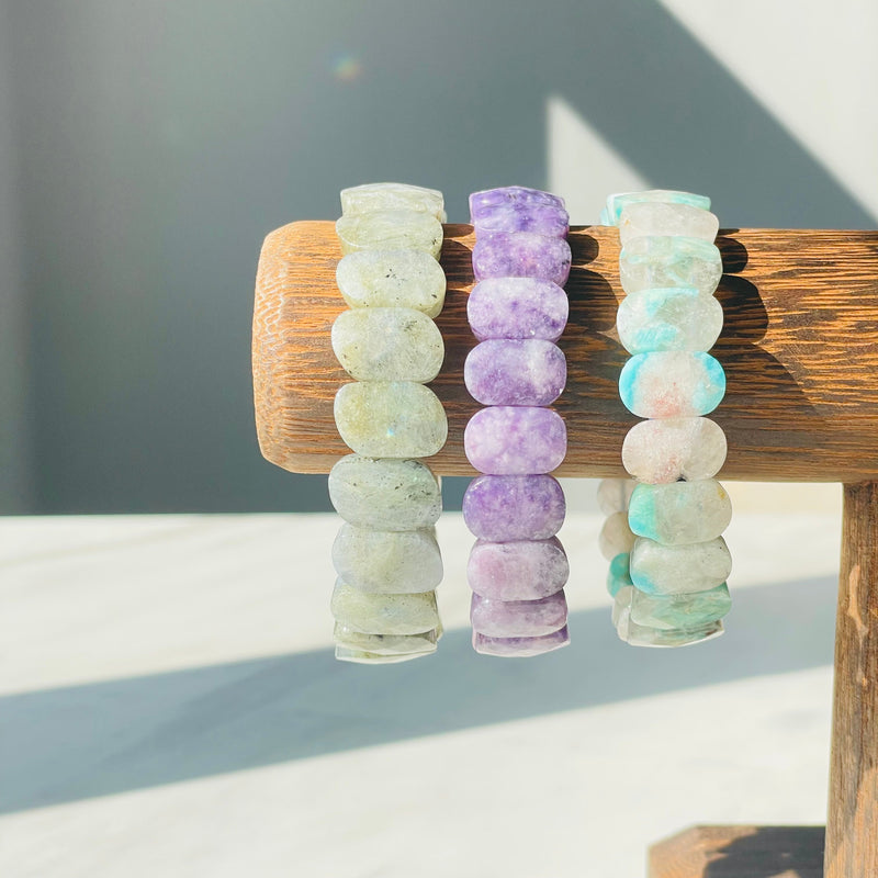 Labradorite Lepidolite Amazonite bracelets on wood display