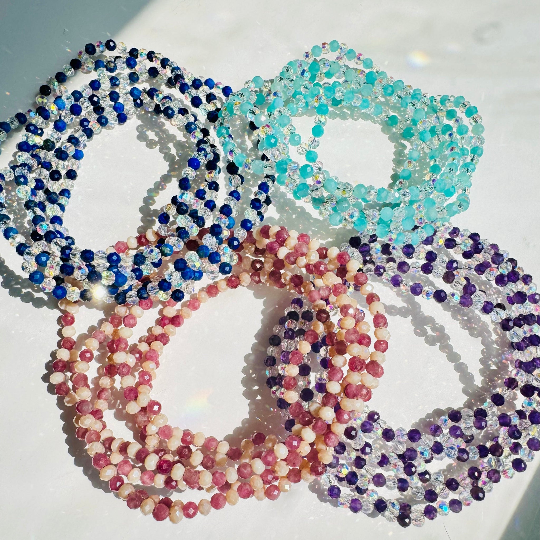 colorful tantric necklaces on white surface