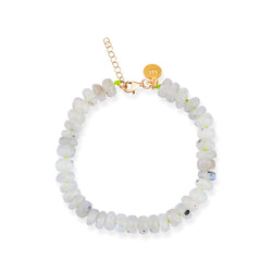 A beaded bracelet featuring white and pink moonstone beads on an elastic cord with a gold-tone clasp.
