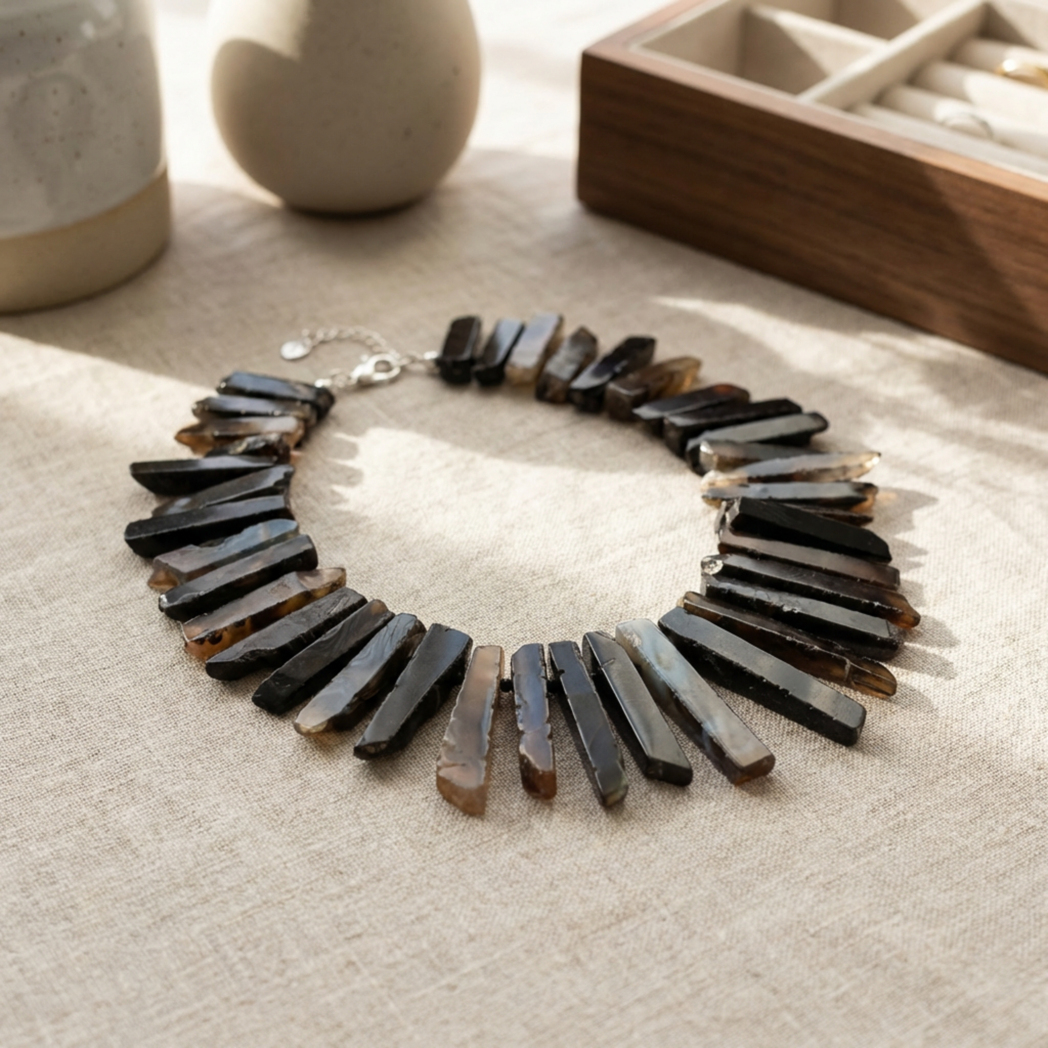 Necklace with black and brown beads on a textured surface