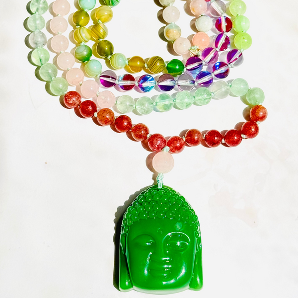 A colorful 108 bead japamala with a Jade Buddha pendant, arranged in a spiral pattern against a white background.