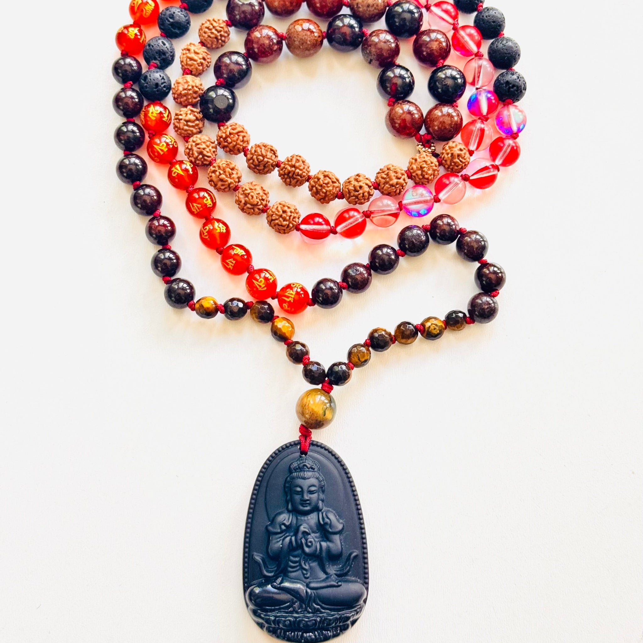 Multi-strand beaded necklace with a pendant on a white background