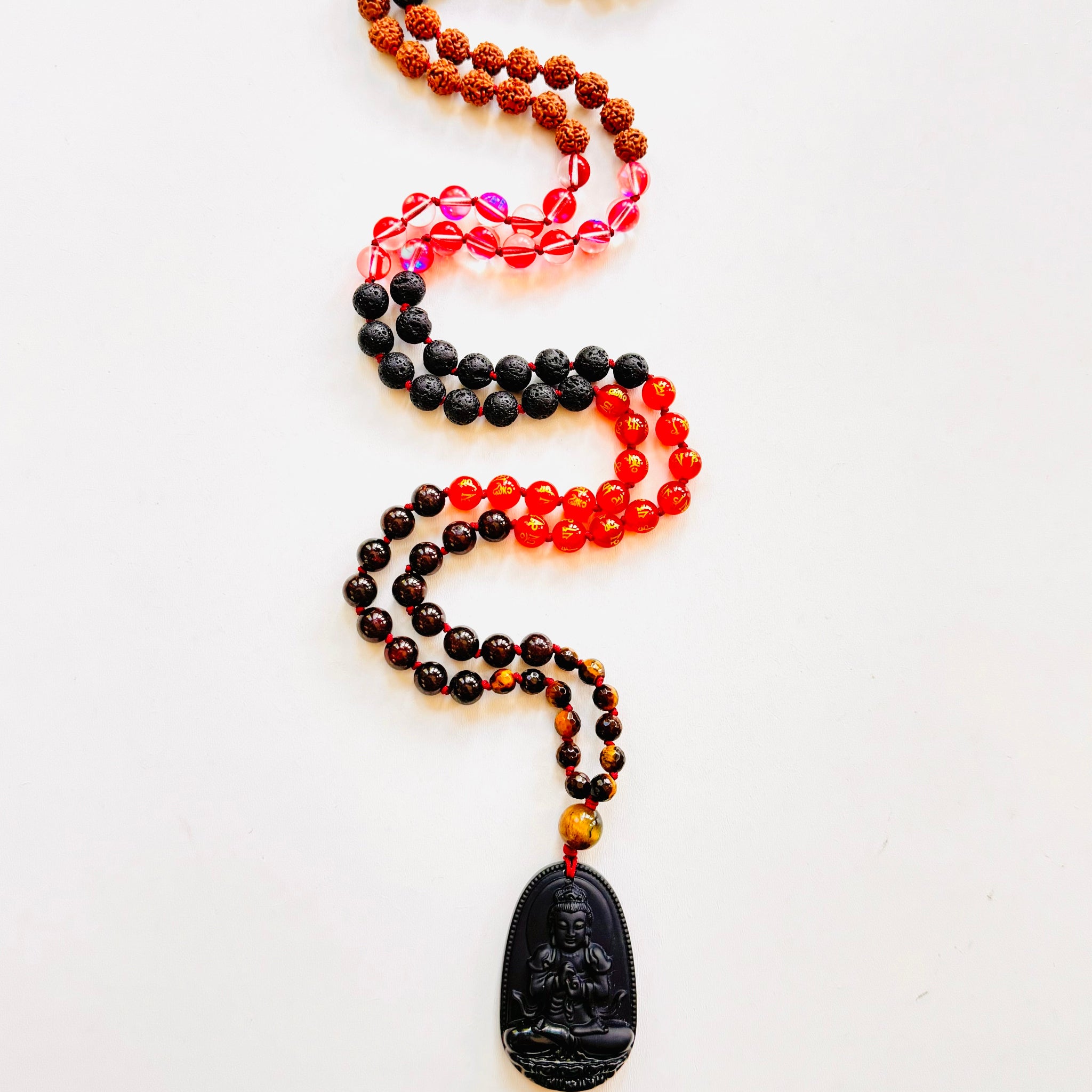 Necklace with black pendant and multicolored beads on white background