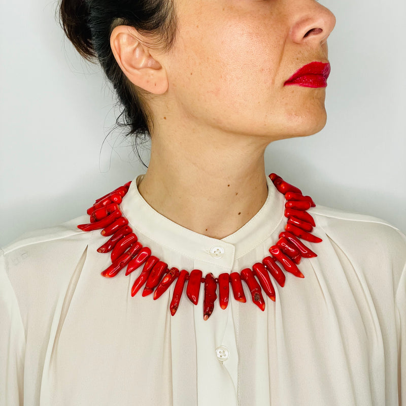 Coral statement necklace on model with white shirt